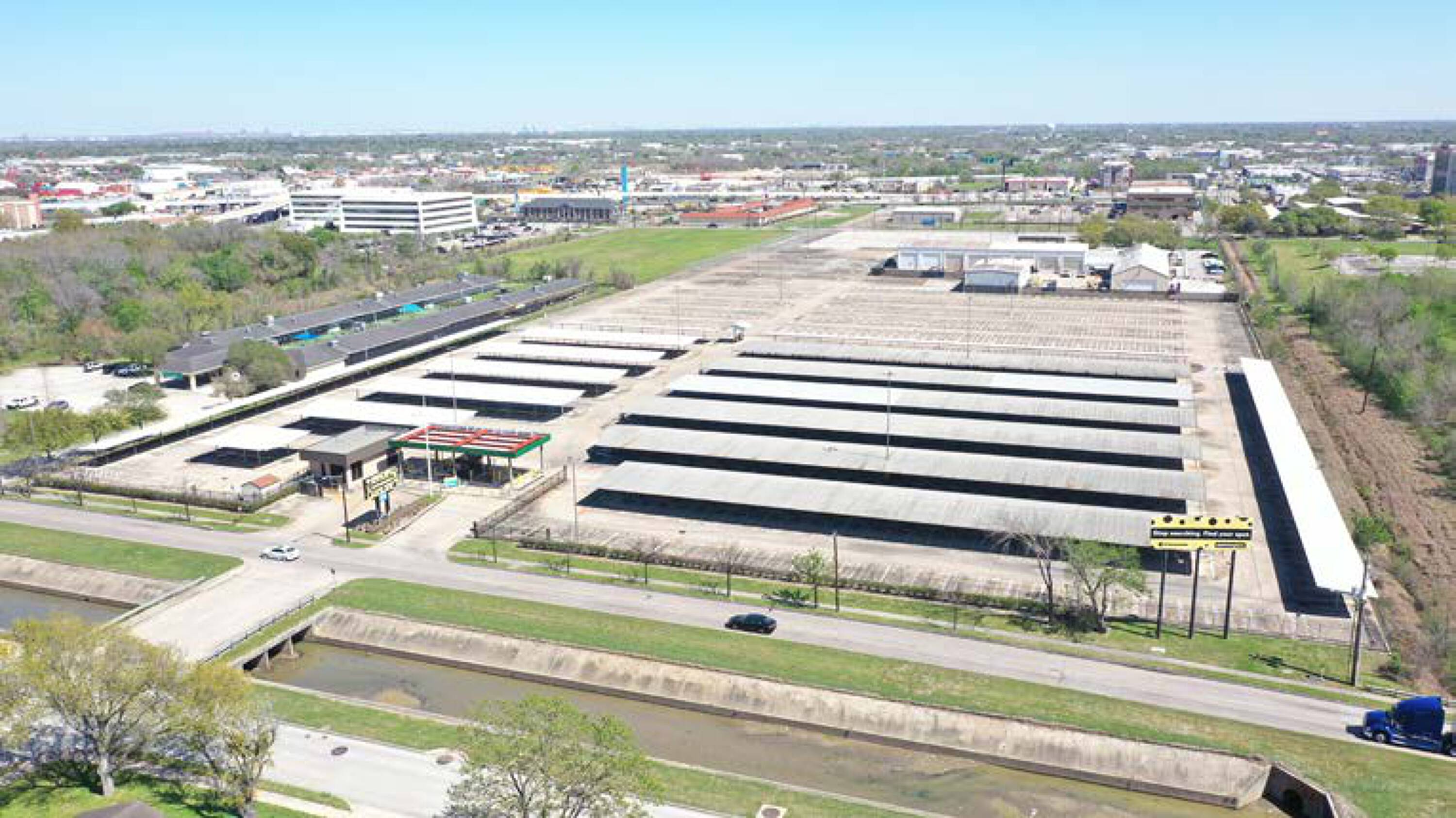 Aerial view of a large industrial property with multiple covered storage areas at 7625 Monroe Rd, Houston, TX.