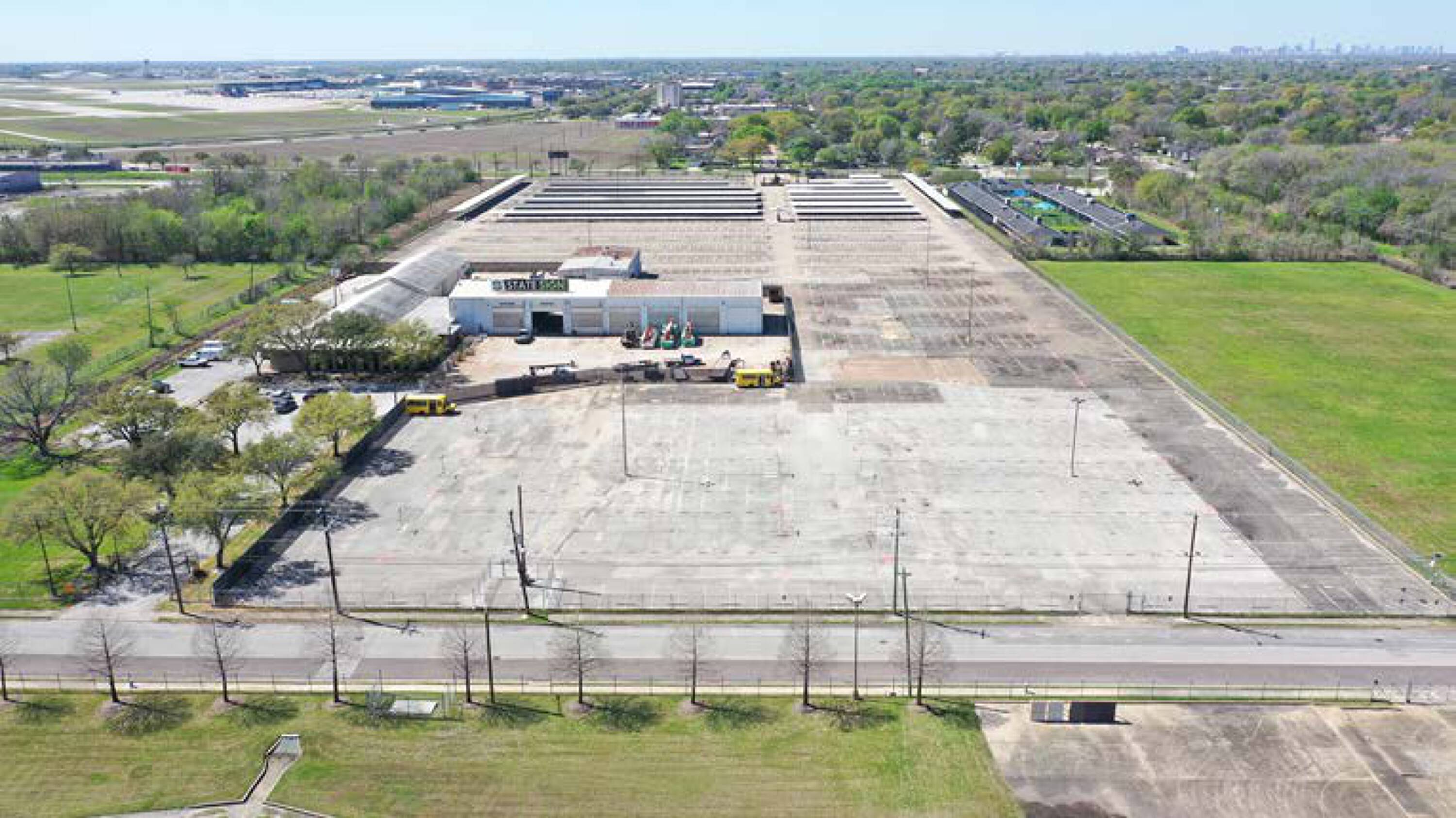 Aerial view of 7625 Monroe Rd, Houston, TX, showcasing industrial buildings and extensive open land.