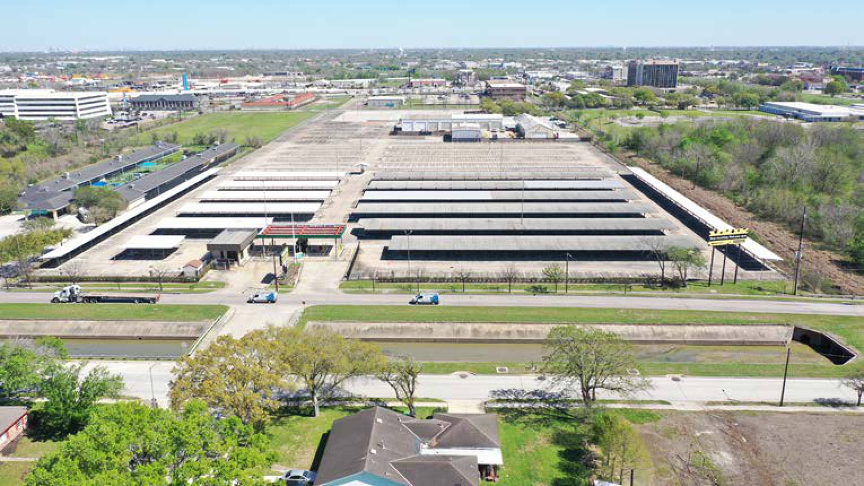 Aerial view of 7625 Monroe Rd, Houston, TX, showcasing large industrial storage facility with solar panels and ample parking.