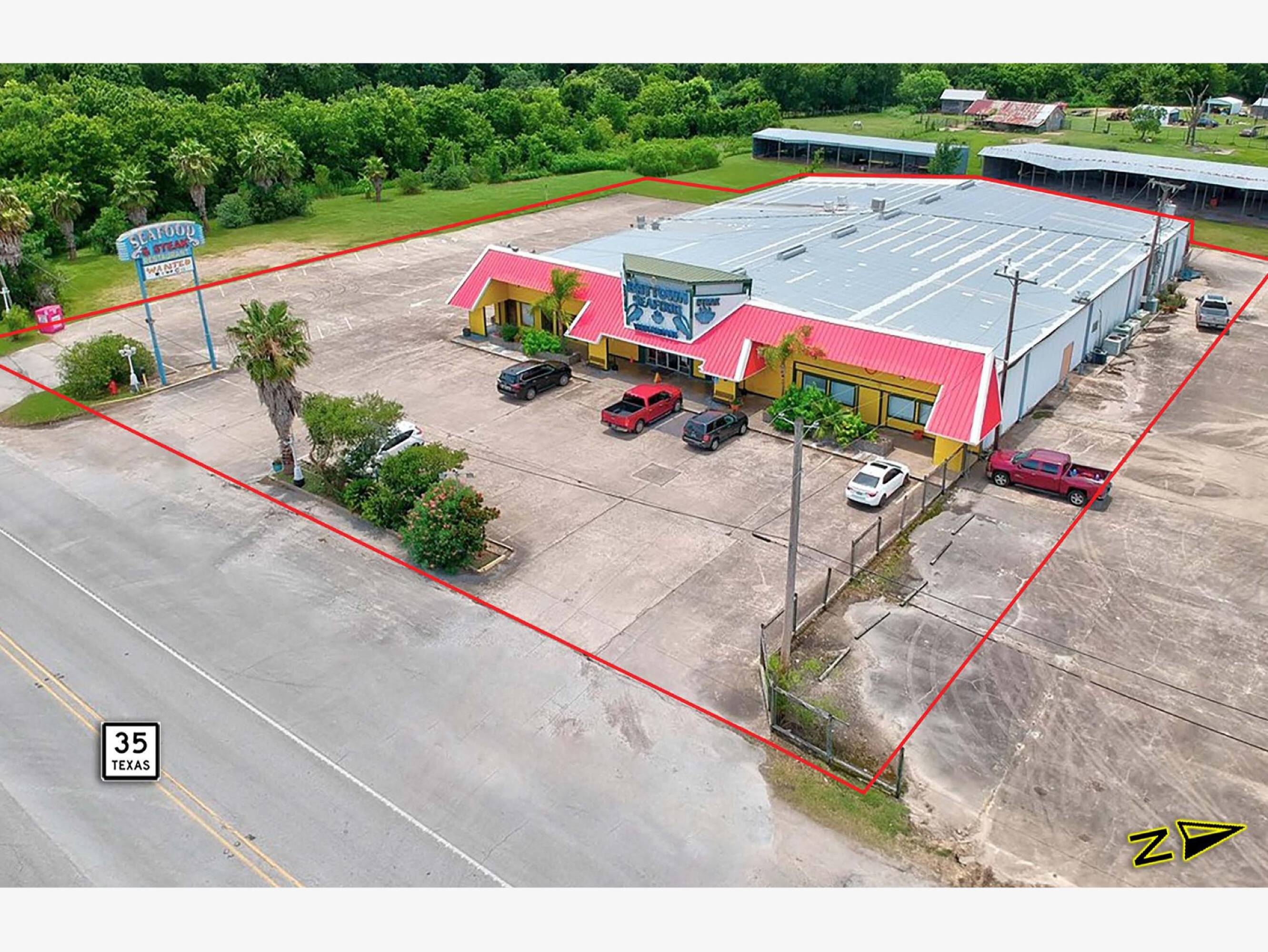 Aerial view of a 18,000 SF building on 1.4 acres with ample parking and loading areas in West Columbia, TX.