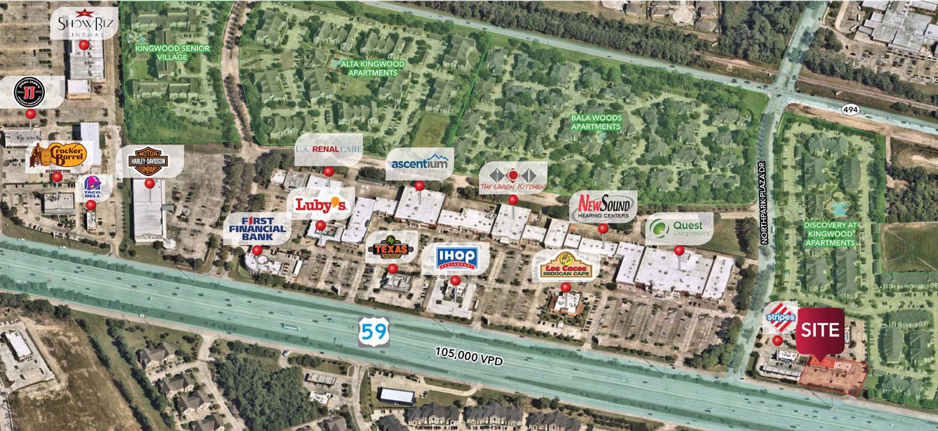 Aerial view of a retail property at 23692 Highway 59 North, Kingwood, TX, with surrounding businesses and ample parking.