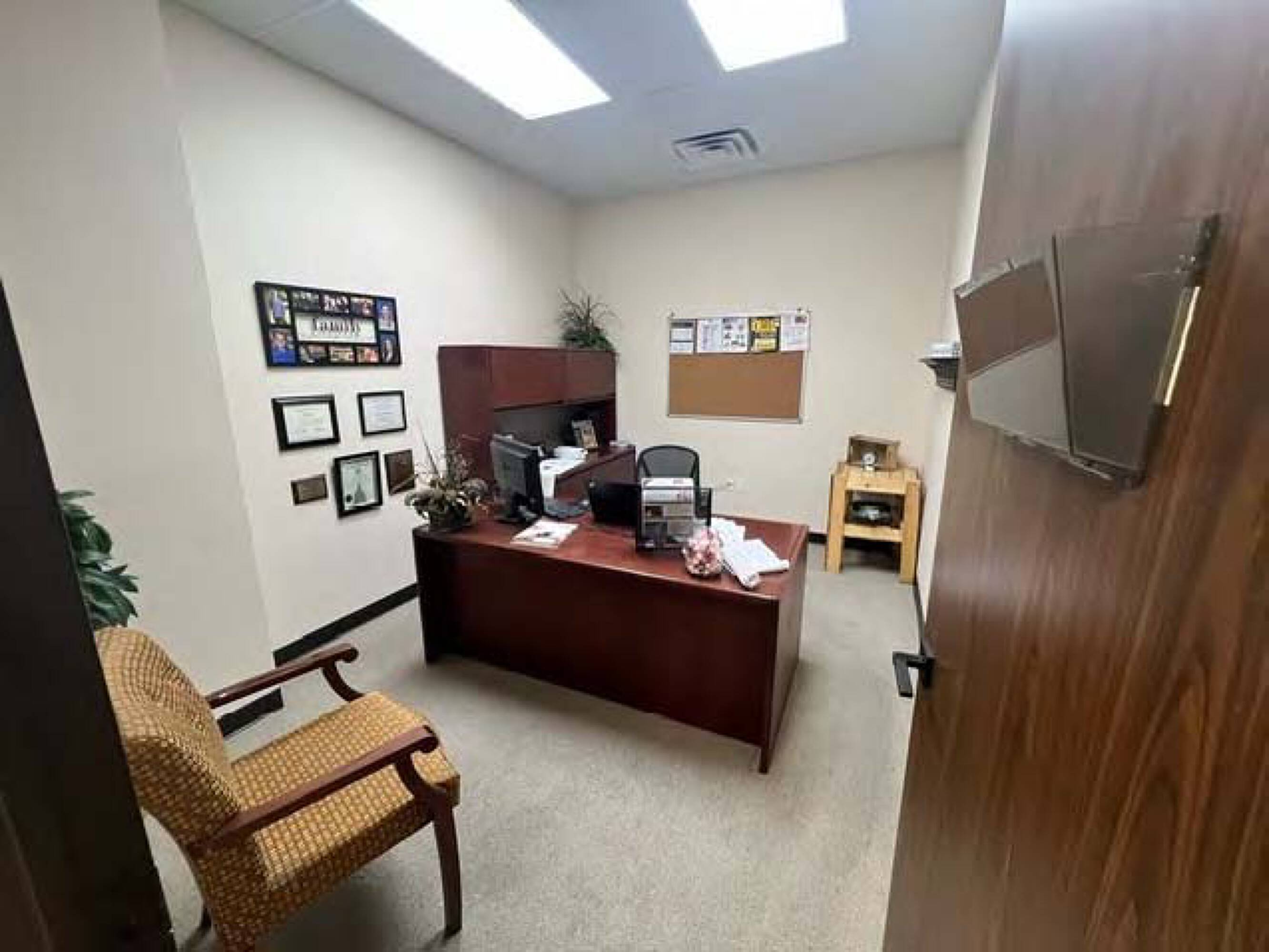 Office space within Four Seasons Business Park featuring a desk, chair, and natural light from large windows.