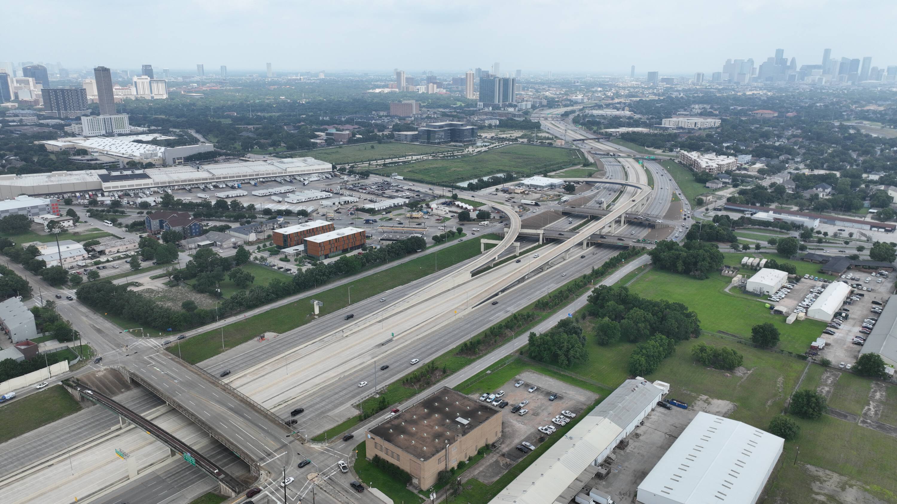 Aerial view of the vacant land at 6897 Ardmore St, Houston, TX, surrounded by industrial and commercial properties with highway access.