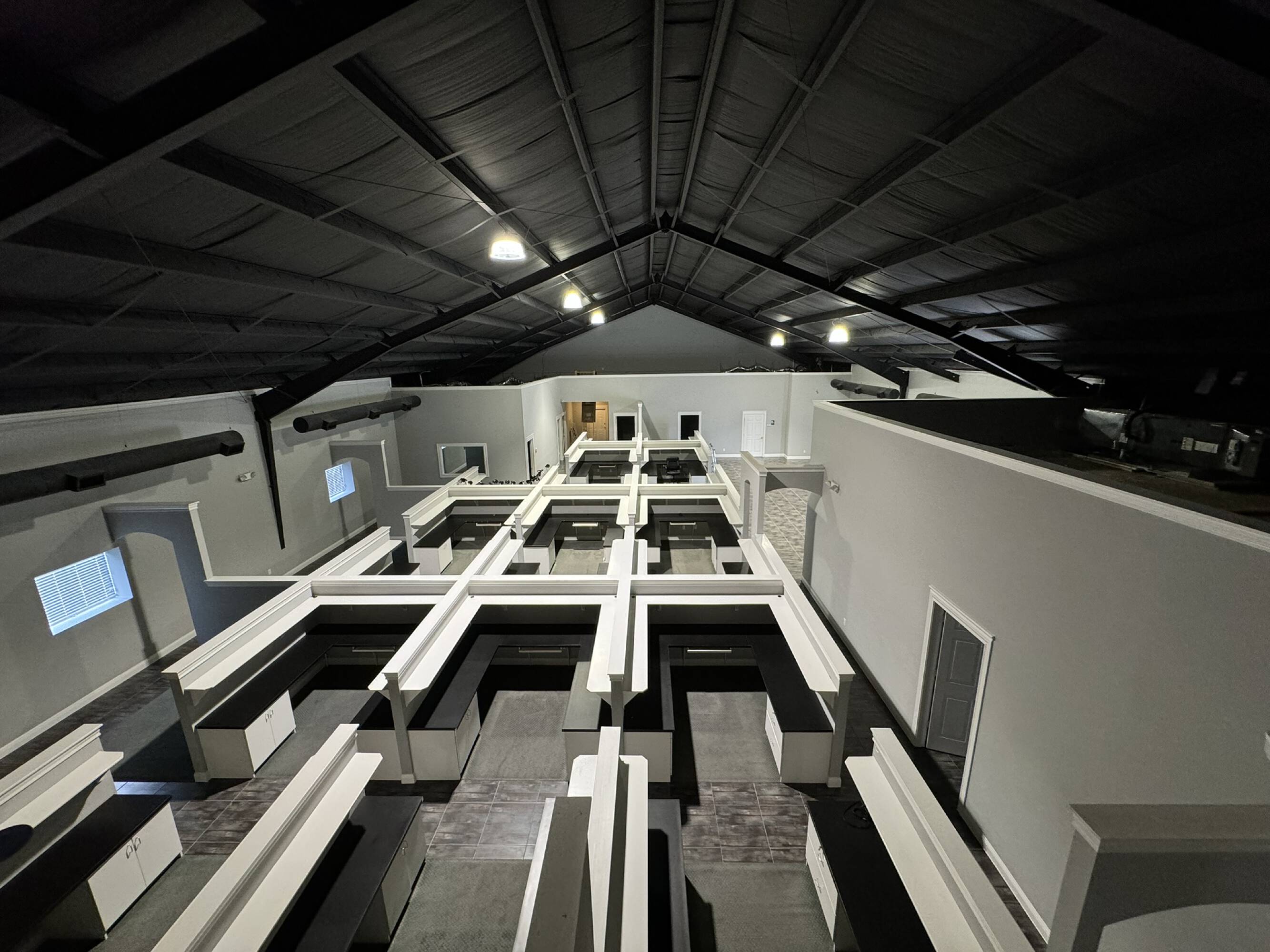 Spacious office warehouse interior with high ceilings, ample lighting, and multiple workstations.