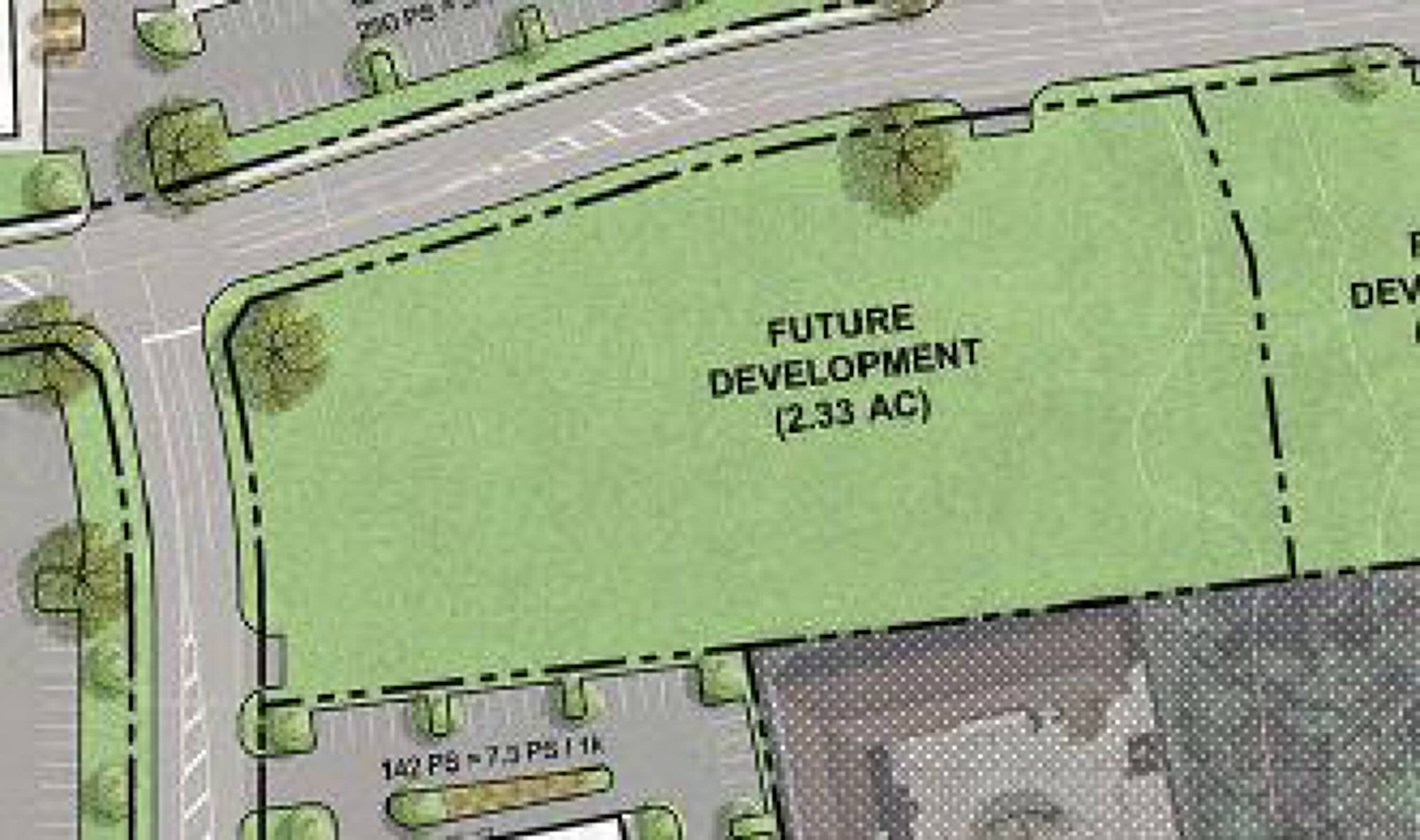 Aerial view of a 2.33-acre future development tract in Baytown, TX, with adjacent parking and commercial neighbors.