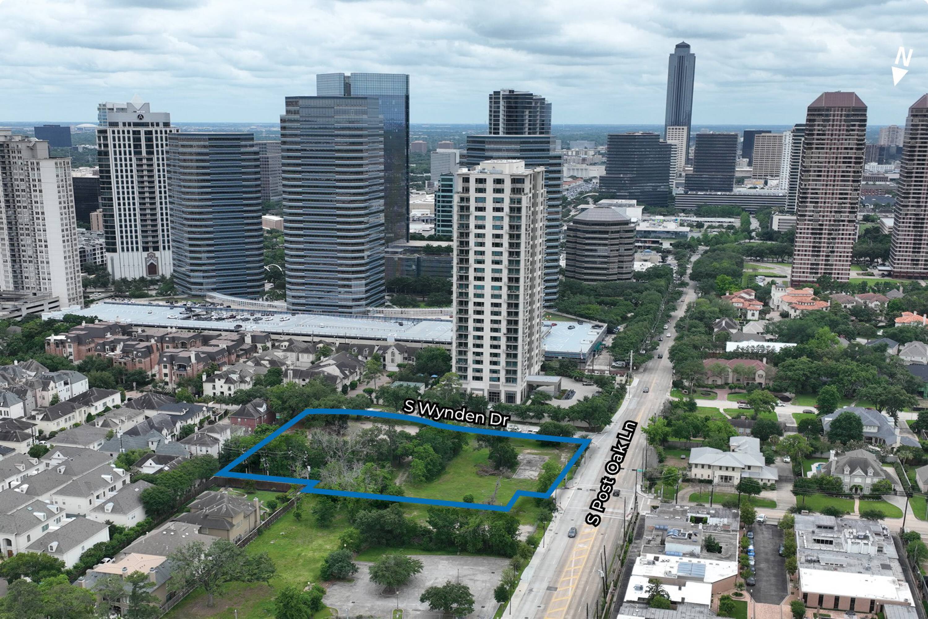 Aerial view of a vacant land parcel at 1175 S Post Oak Ln, Houston, TX, surrounded by high-rise buildings.