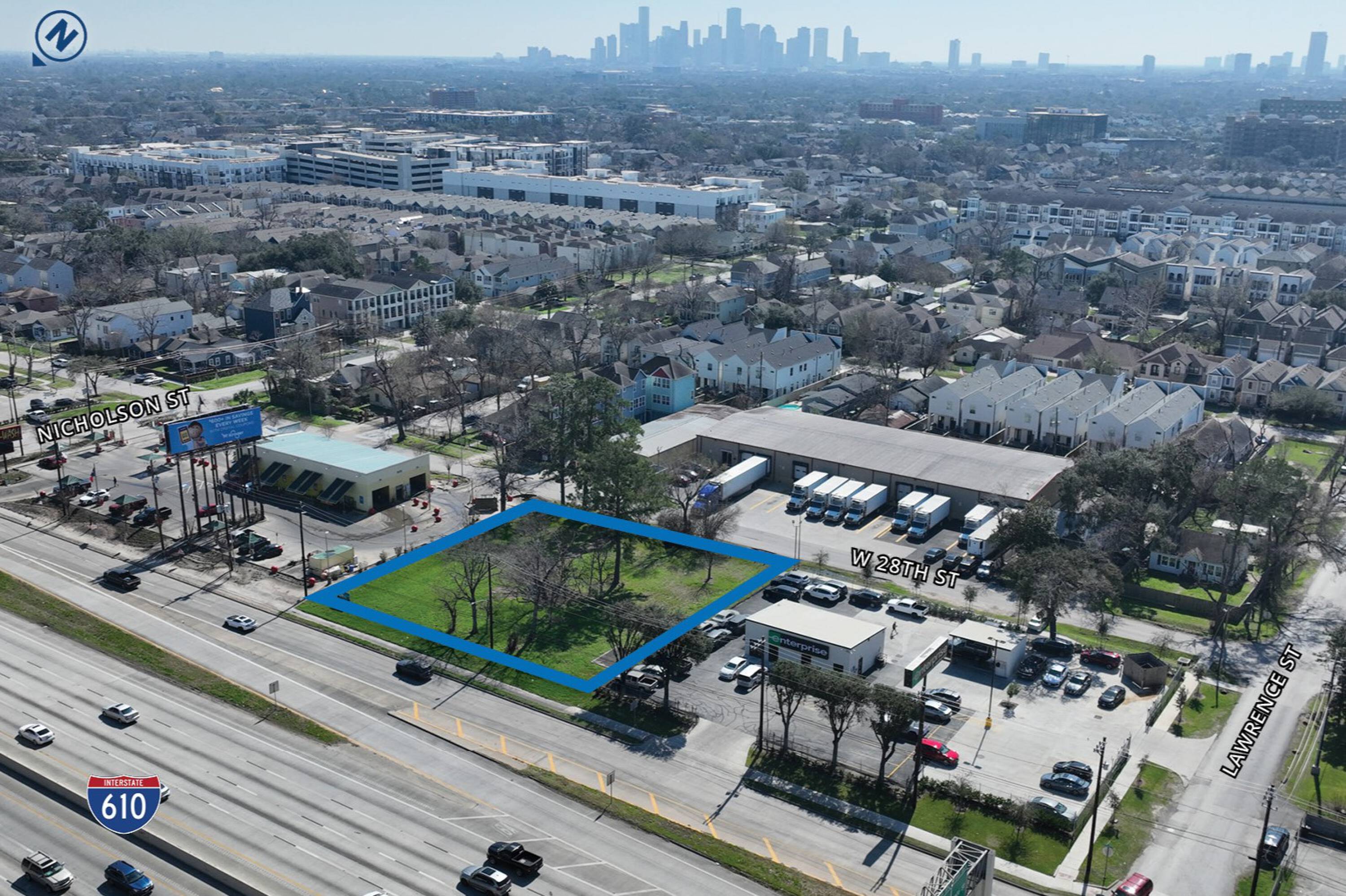 Aerial view of a vacant land parcel at 529 W 28th St, Houston, TX, with surrounding commercial buildings and downtown skyline in the background.
