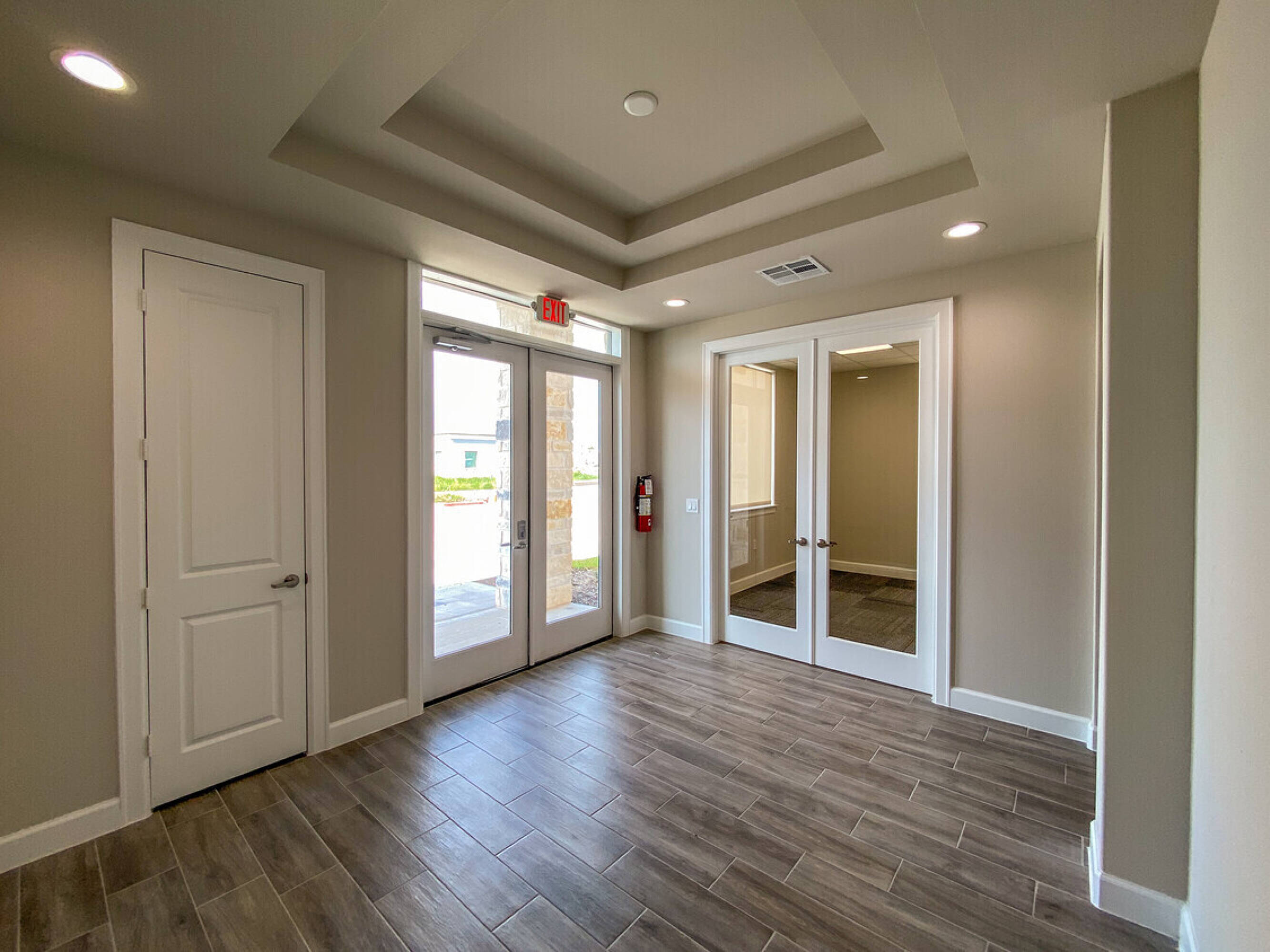 Entryway of Woodforest Medical Center - Building 12 with double glass doors and polished wood flooring.