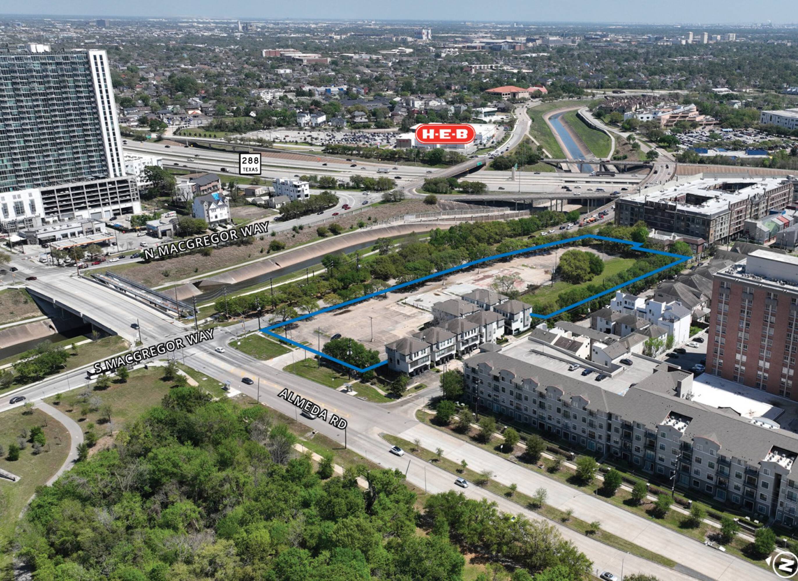 Aerial view of vacant land at 2306 S MacGregor Way, Houston, TX, surrounded by high-rise buildings and retail.