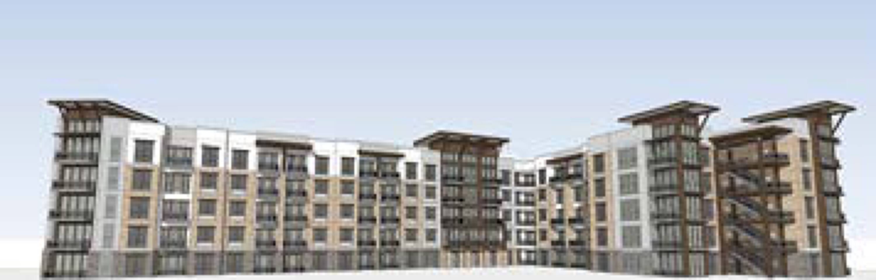 Modern multi-family residential building with large windows and balconies in Houston, TX.