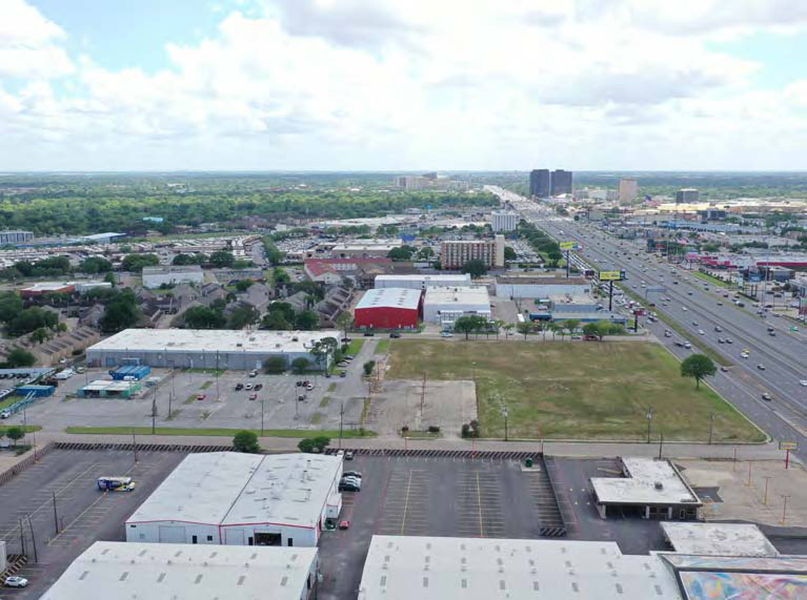 Aerial view of the vacant land at 6767 Southwest Fwy, Houston, TX, surrounded by commercial and industrial buildings.