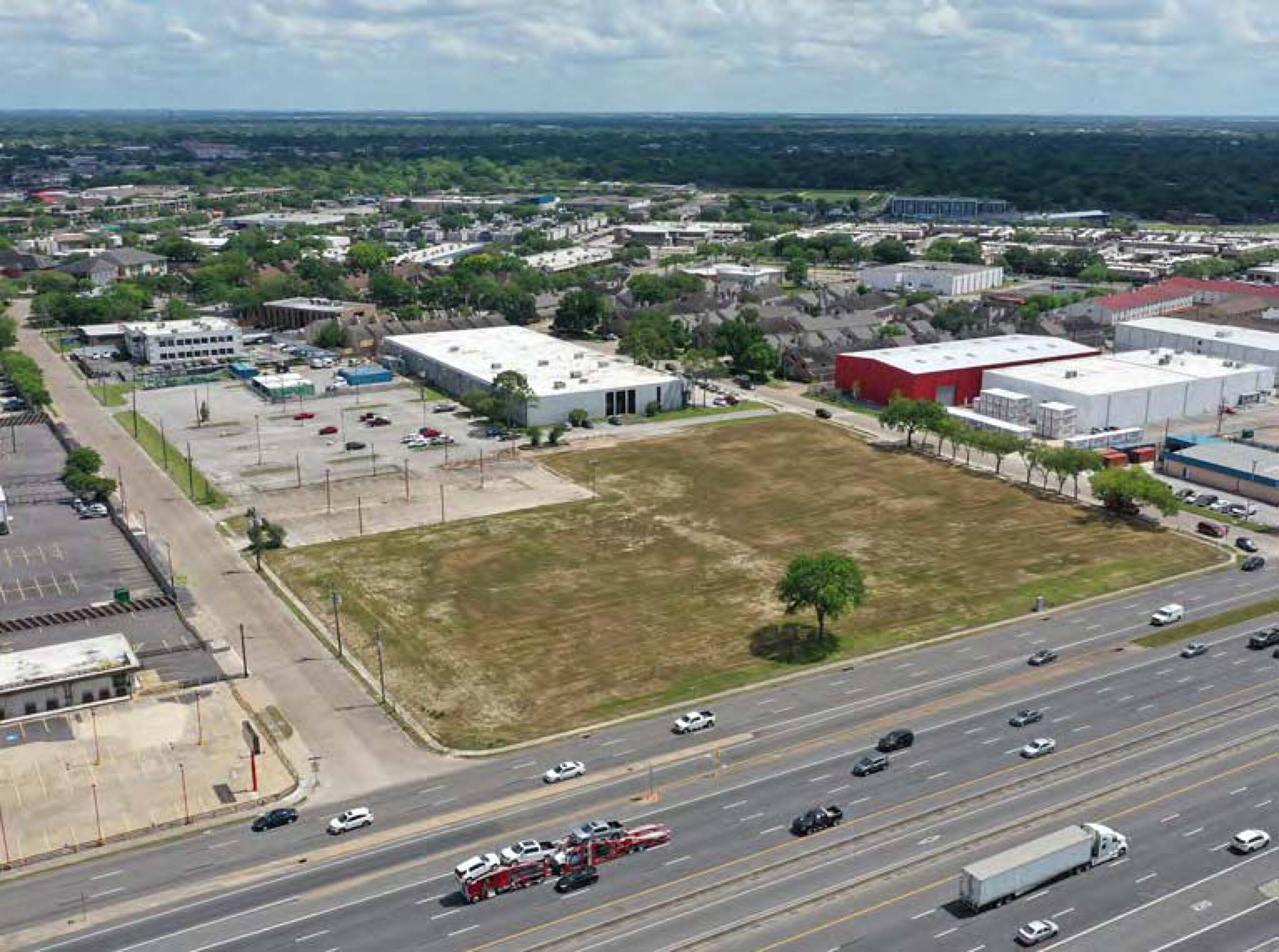 Aerial view of 6767 Southwest Fwy, Houston, TX, showing a large vacant land parcel with surrounding commercial buildings.