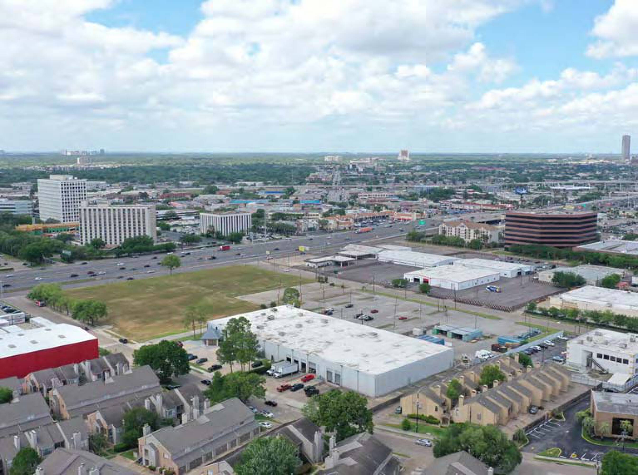 Aerial view of the undeveloped land at 6767 Southwest Fwy, Houston, TX, surrounded by commercial and residential buildings.