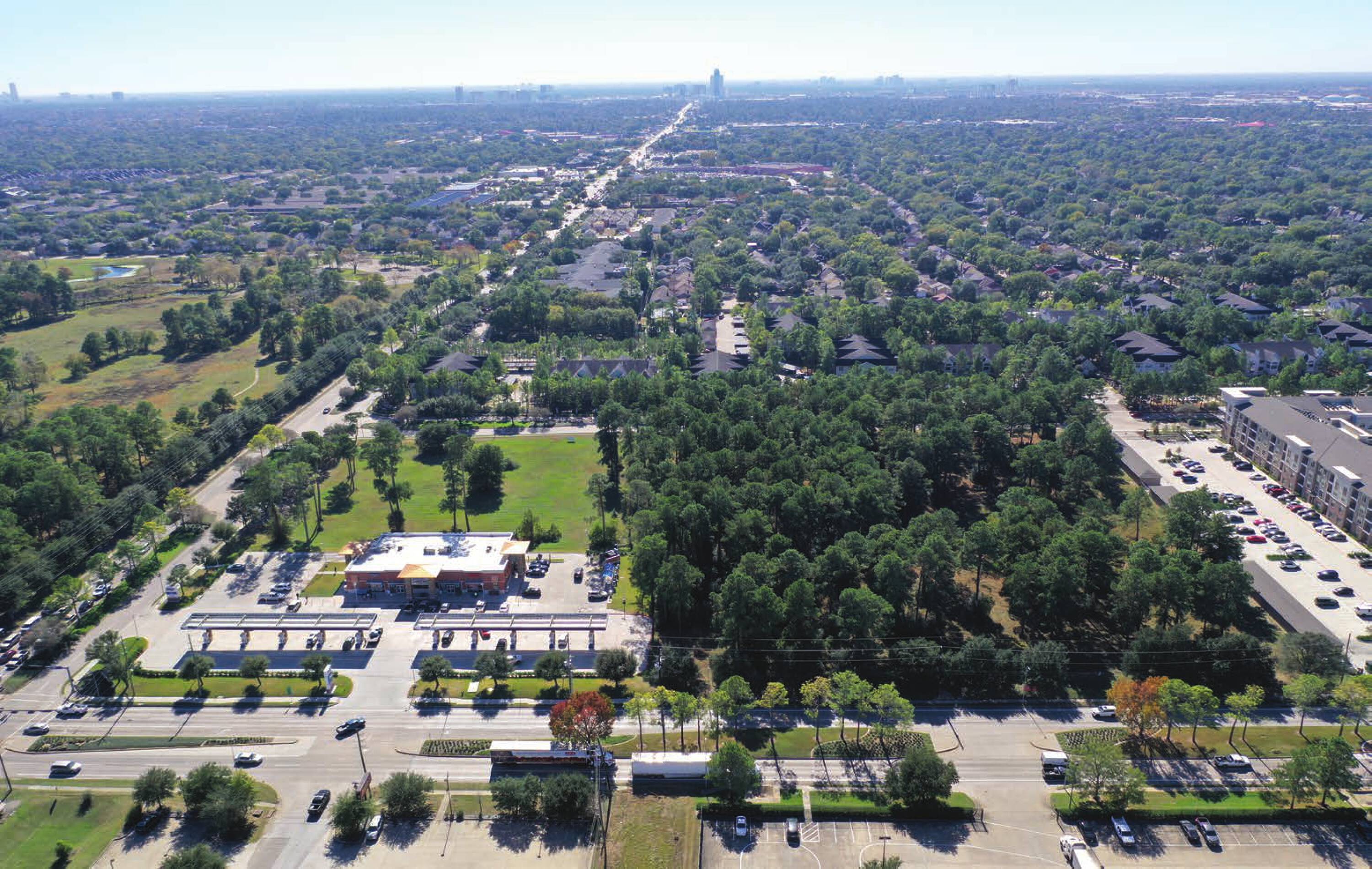 Aerial view of the vacant land at SWC Clay Road & Gessner Road, Houston, TX, surrounded by residential and commercial areas.