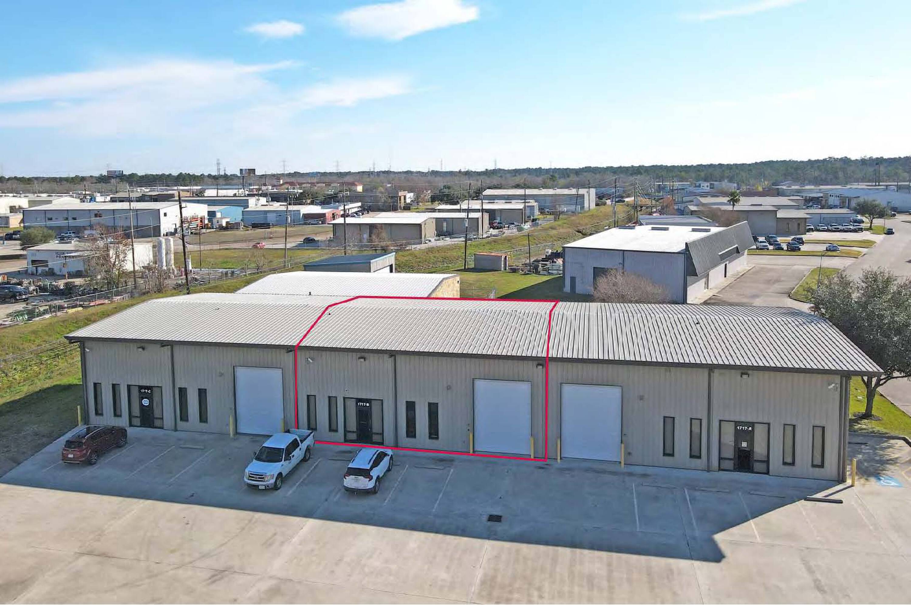 Aerial view of a well-maintained industrial flex building with ample parking and loading areas.