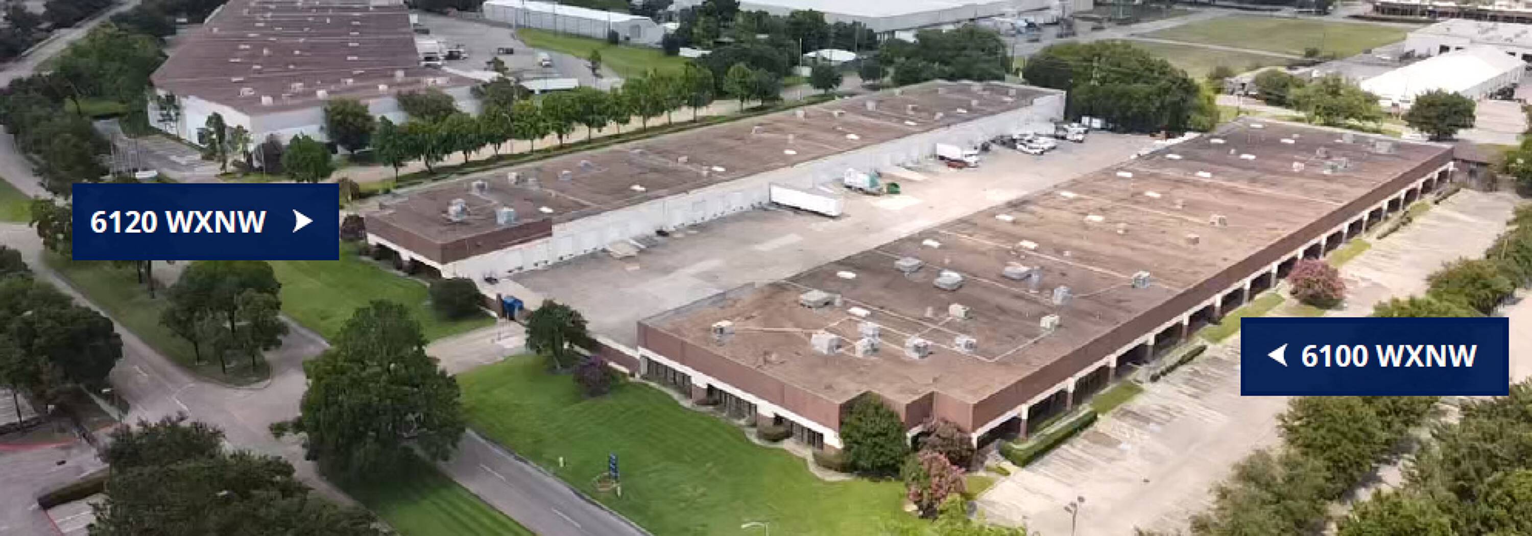 Aerial view of a well-maintained industrial warehouse with ample parking and loading areas.