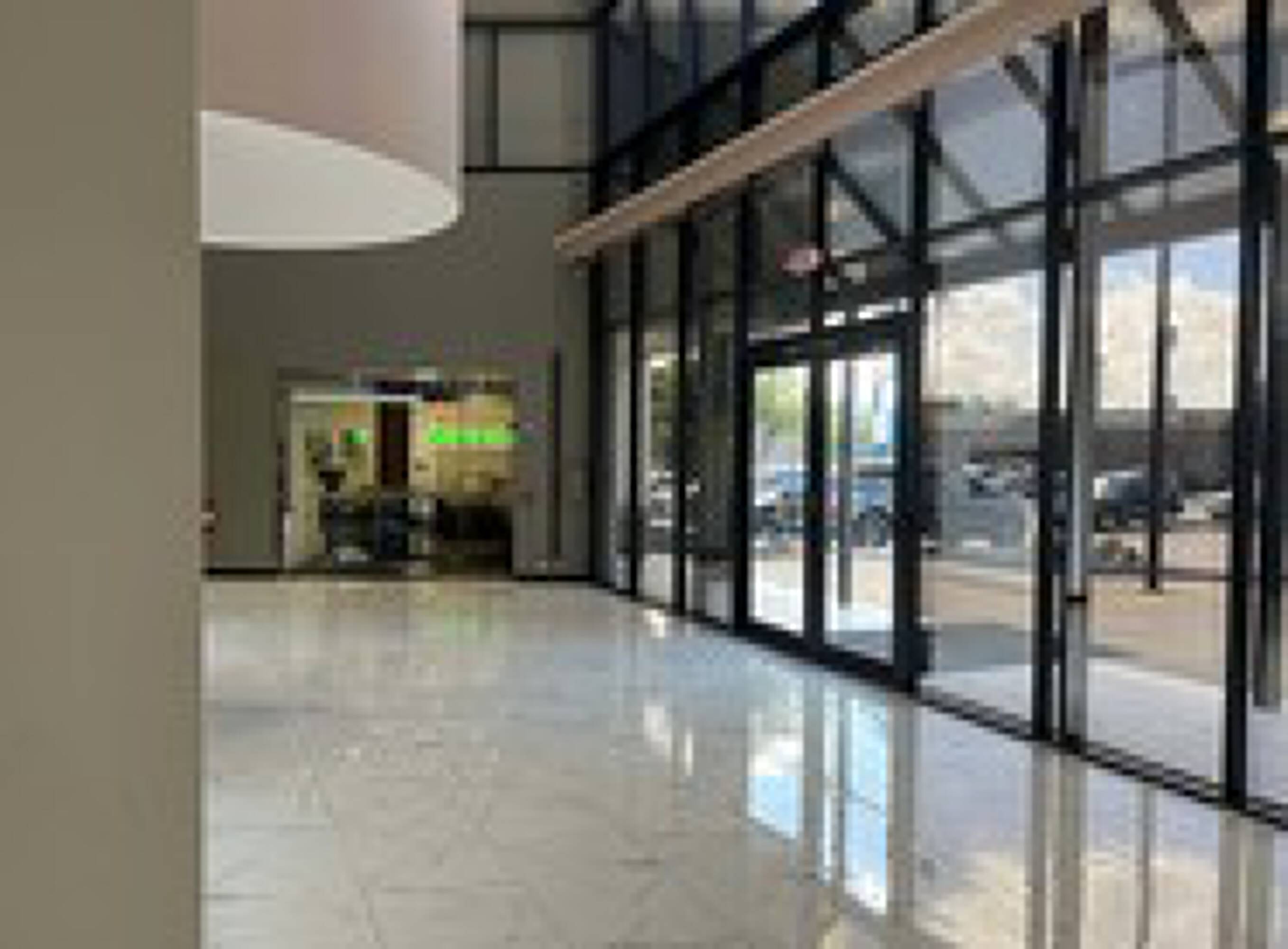 Spacious lobby with large windows and polished tile flooring in the Chase Bank Office Building.