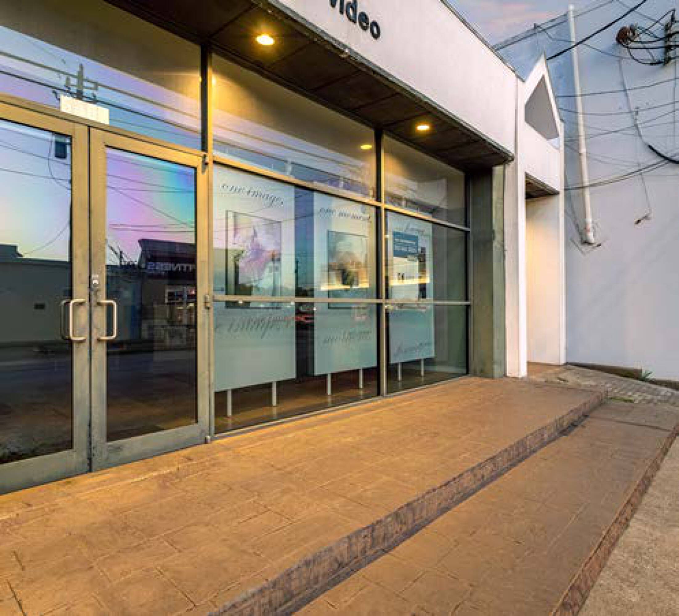 Large glass windows and double door entrance of a retail or office property at 5407 Kelvin Dr, Houston, TX.