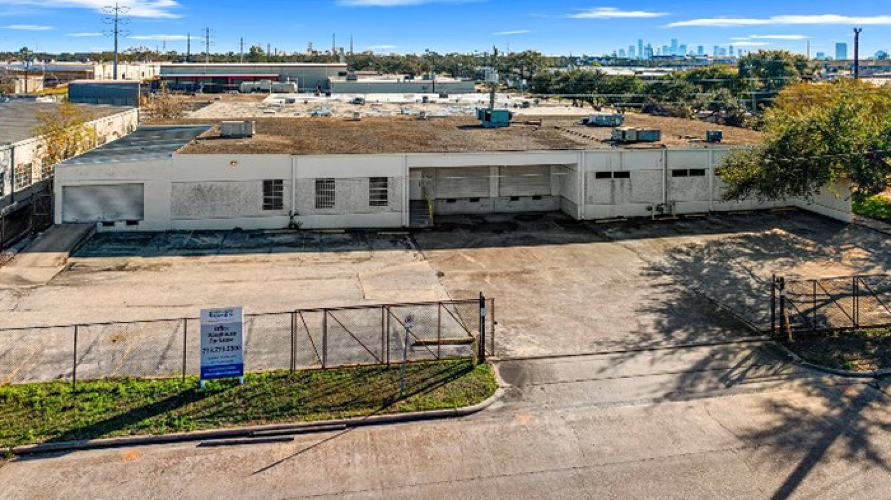 Aerial view of 6880 Wynnwood Lane, an industrial warehouse property in Houston, TX with ample parking and loading docks.