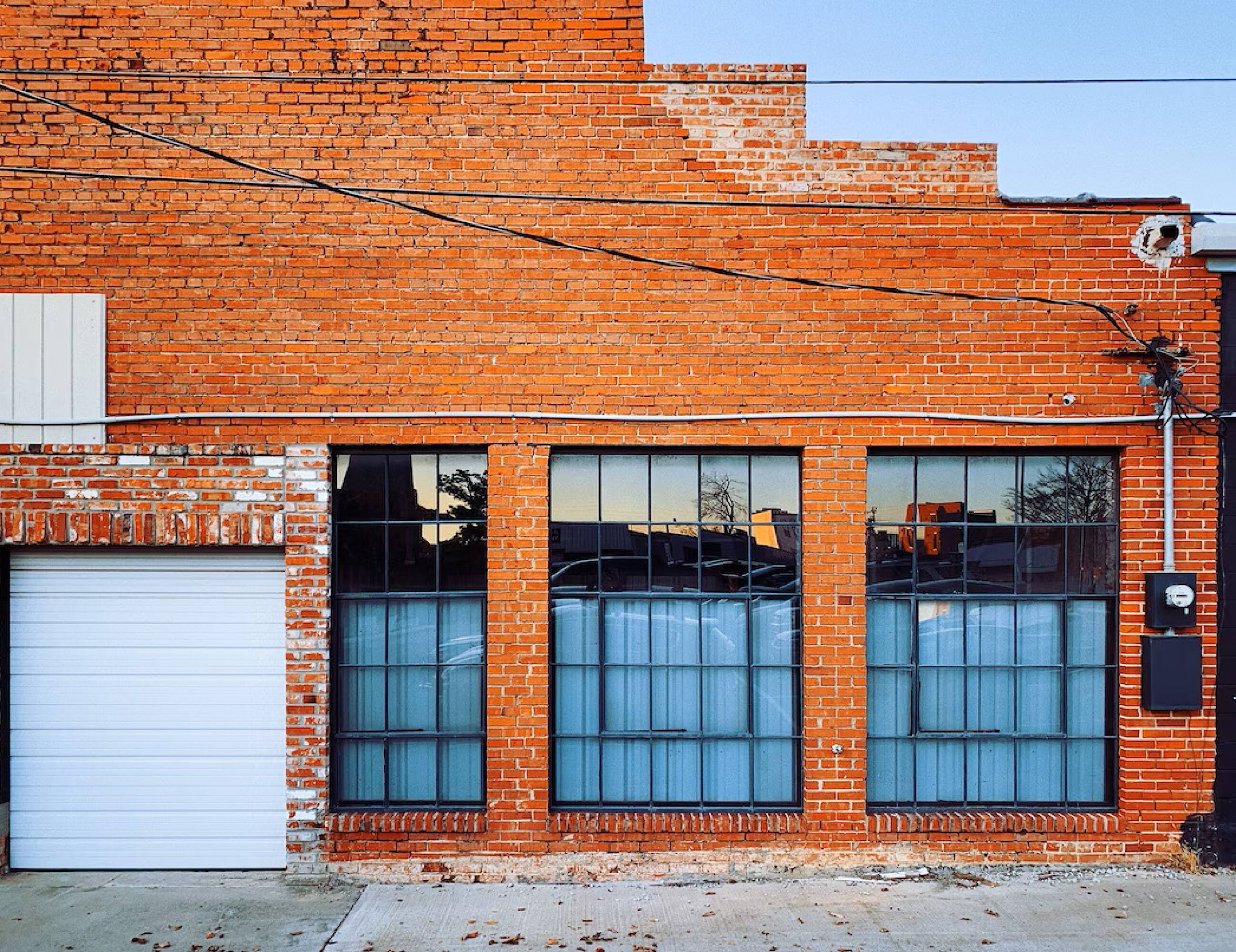 Brick retail building with large windows at The Bend, Humble, TX.