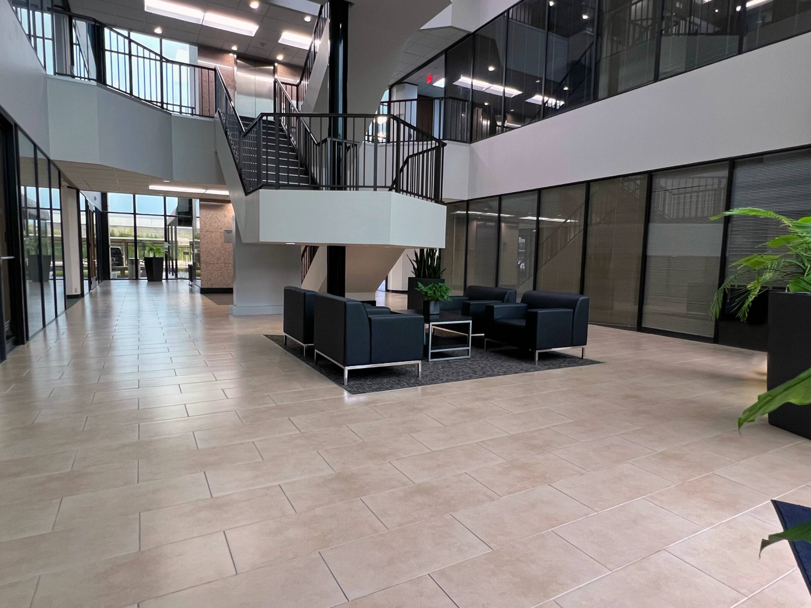 Modern office lobby with large windows, natural light, and contemporary seating area at Sixteen 360 Park Ten Place, Houston, TX.