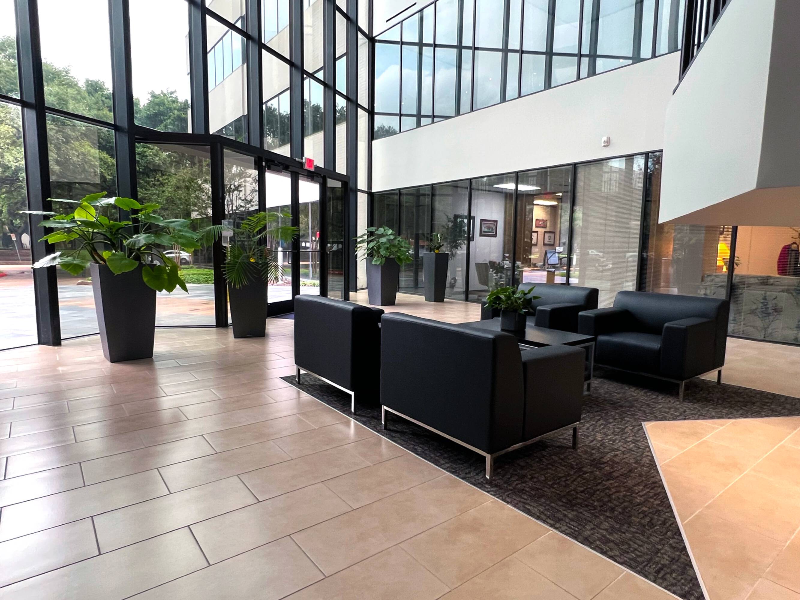 Modern office lobby with large windows, comfortable seating, and ample natural light at Sixteen 360 Park Ten Place in Houston, TX.