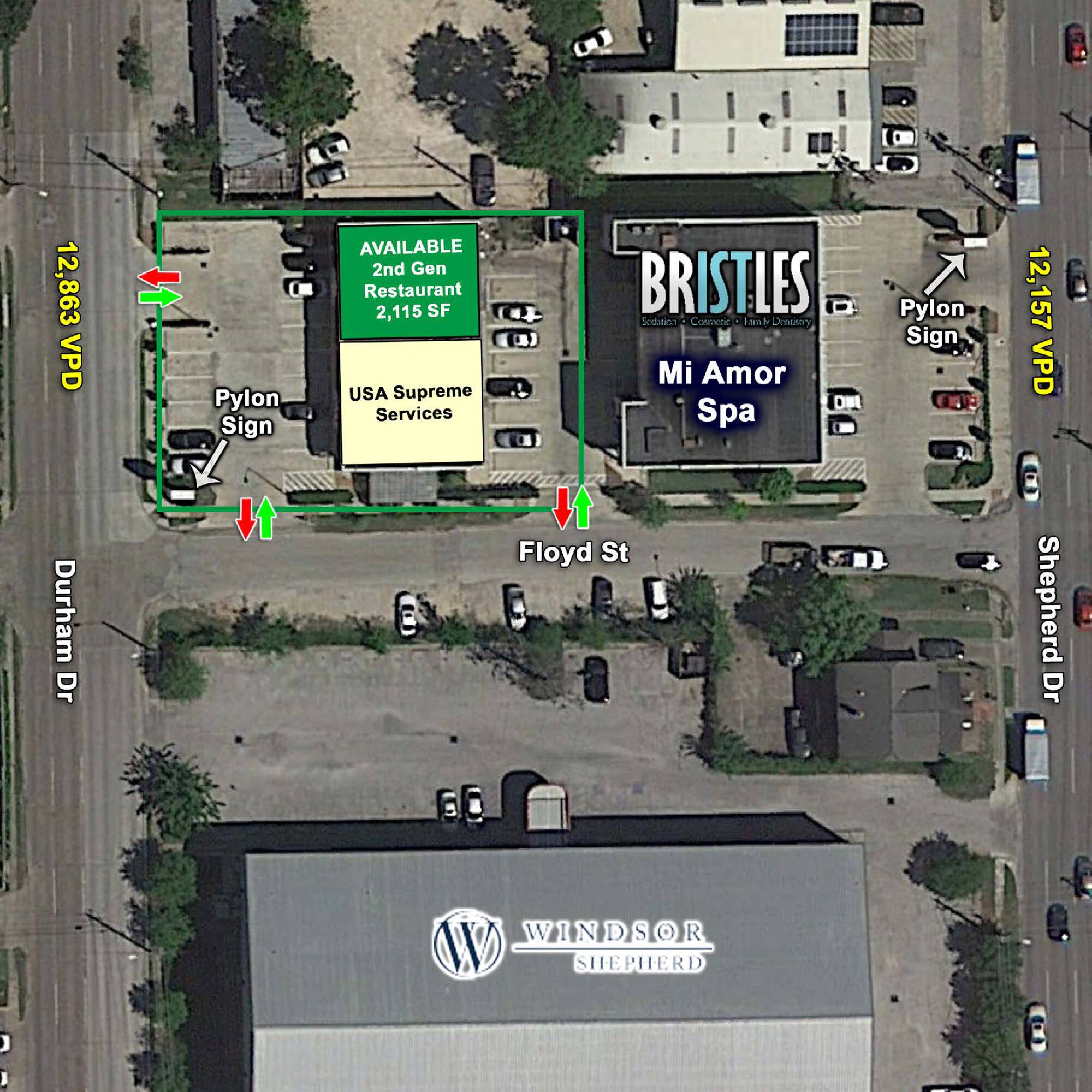 Aerial view of a commercial property with retail and restaurant tenants, ample parking, and clear signage.