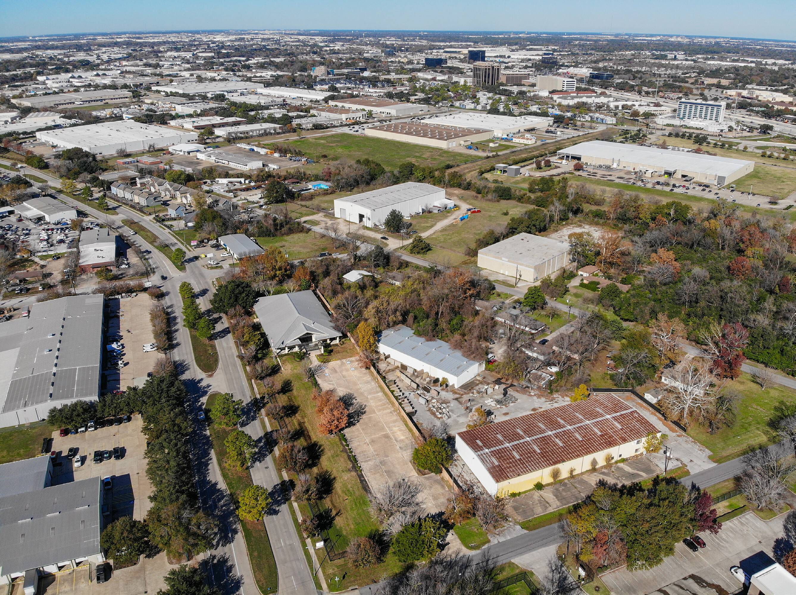 Aerial view of 6950 W 43rd St, Houston, TX, showcasing an industrial office property with ample parking and green surroundings.