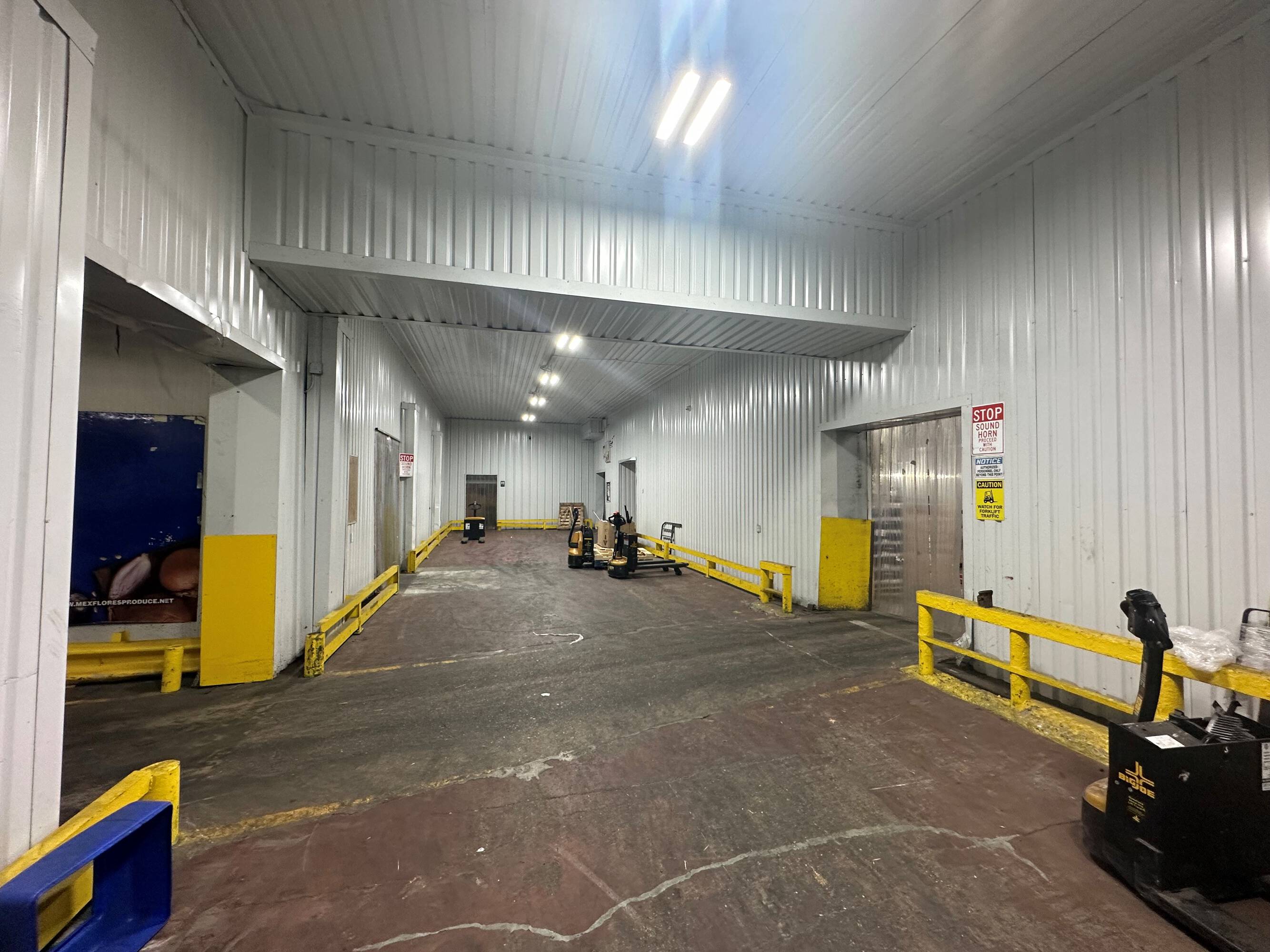 Interior view of an industrial space at 2216 Silver Street with high bay lighting and loading areas.