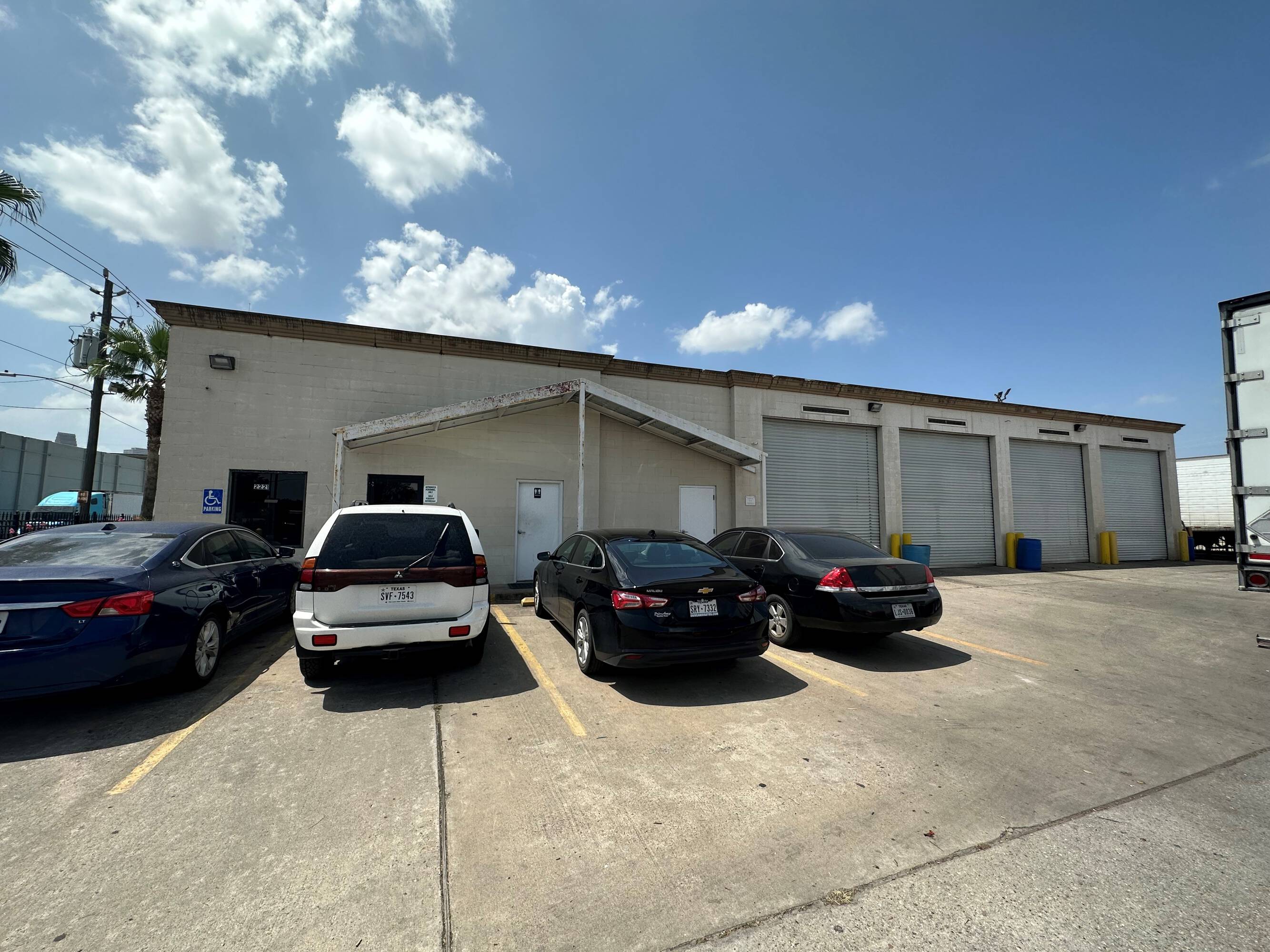 Front view of a single-story industrial building with overhead doors and surface parking at 2216 Silver Street, Houston, TX.