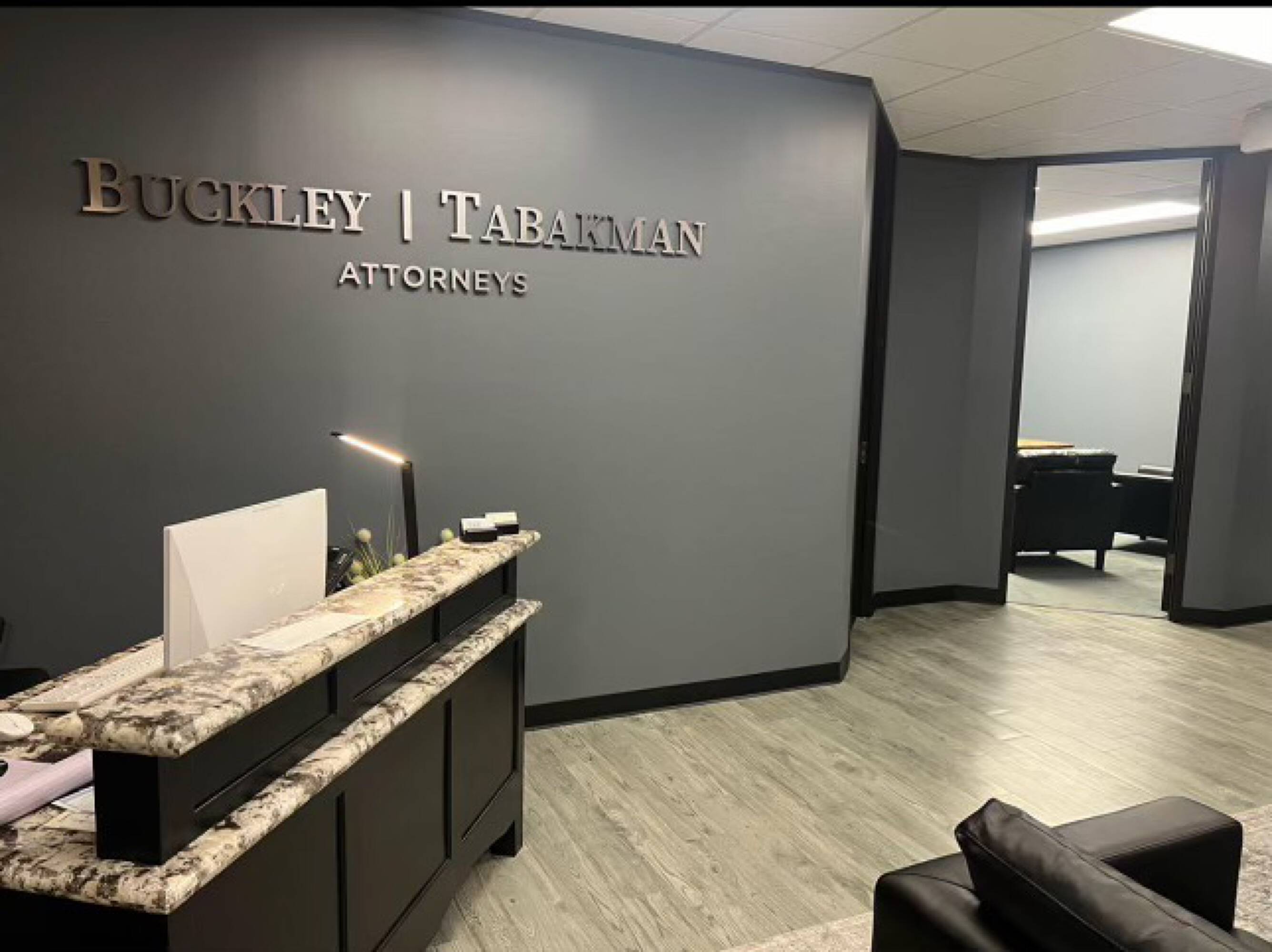 Reception area of Law Office of Sean Buckley with modern decor and professional signage.