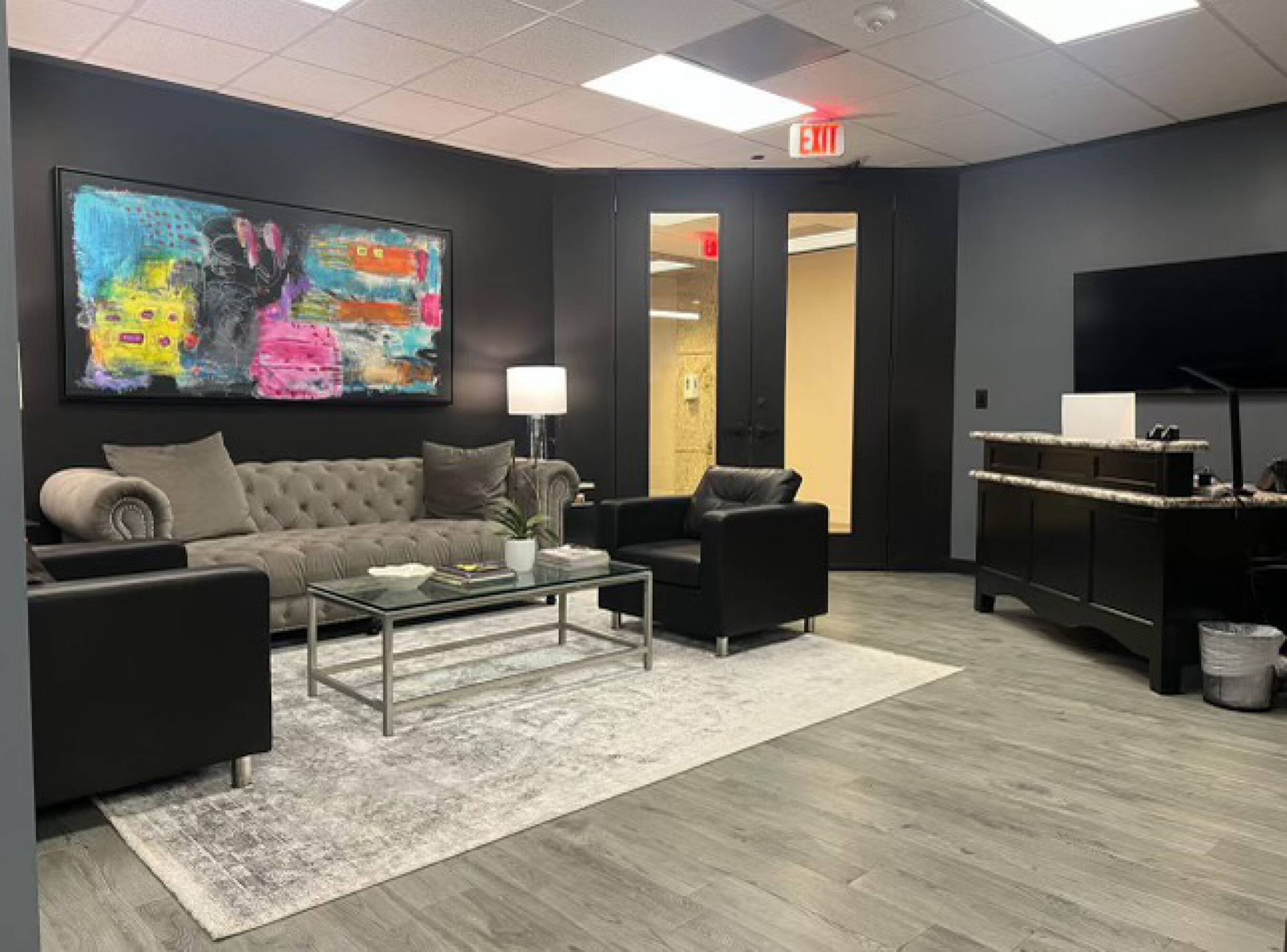 Modern office space with reception area, seating, and desk at Law Office of Sean Buckley, Woodway Center, Suite 300W.