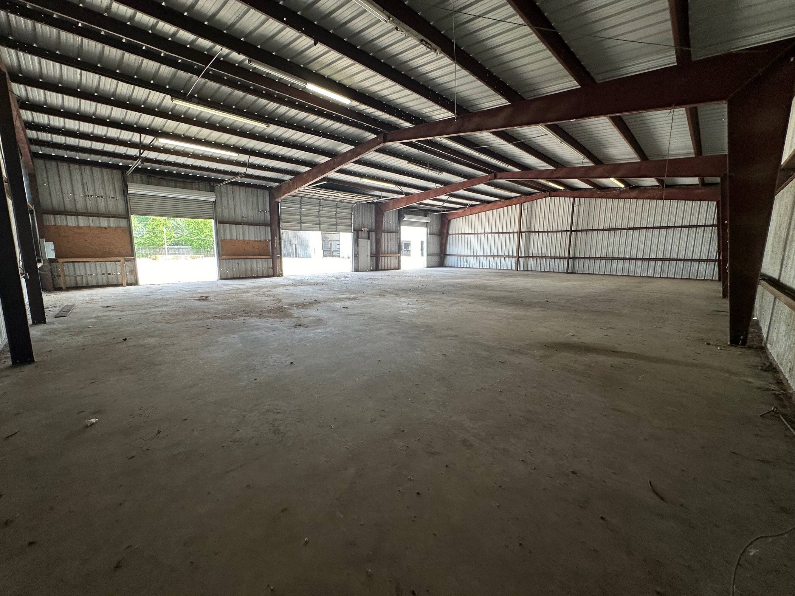 Spacious industrial warehouse with high ceilings and large overhead doors at Brittmoore Business Park.