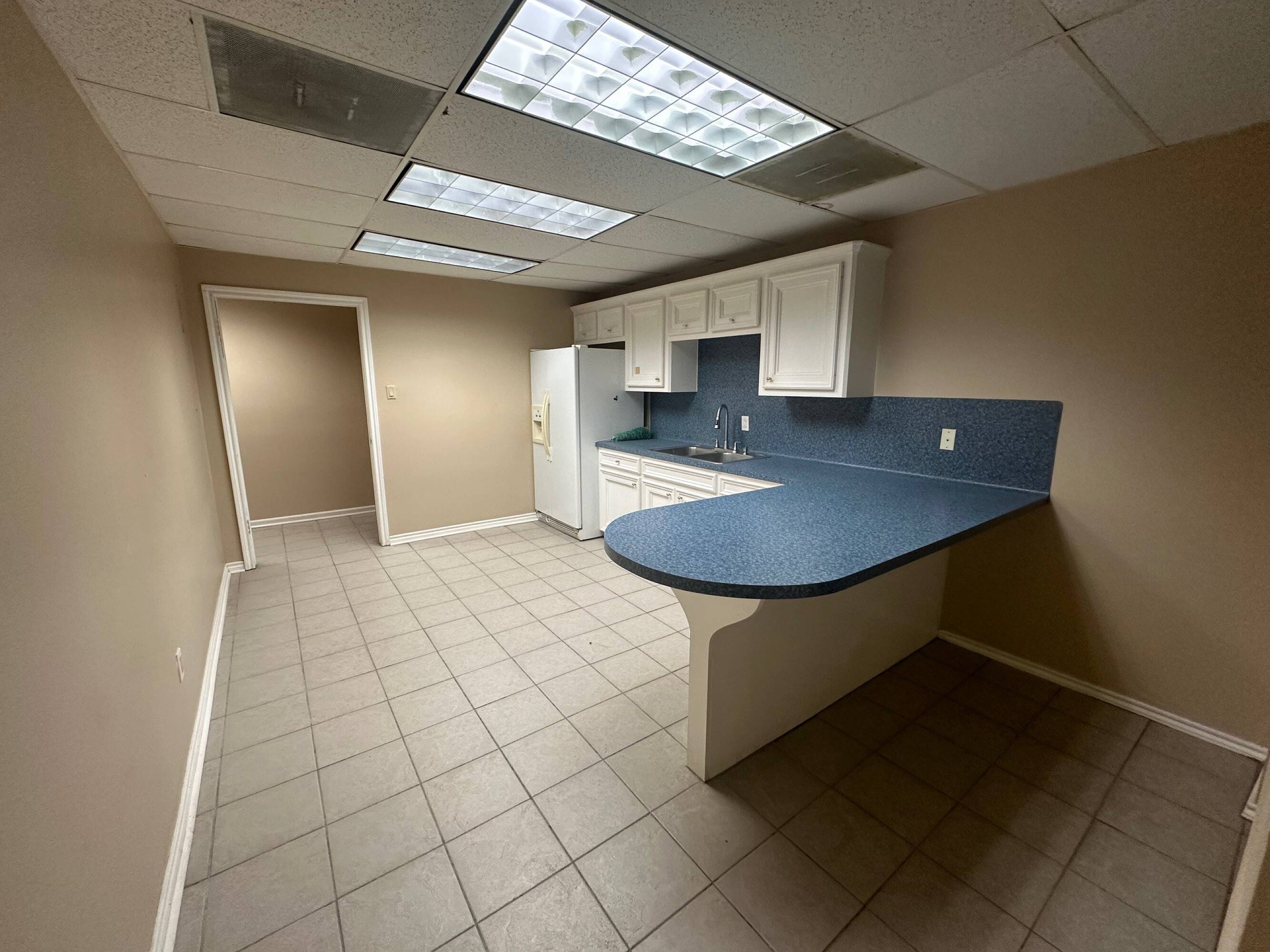 Interior view of an office or industrial space at Brittmoore Business Park with a kitchenette and open layout.