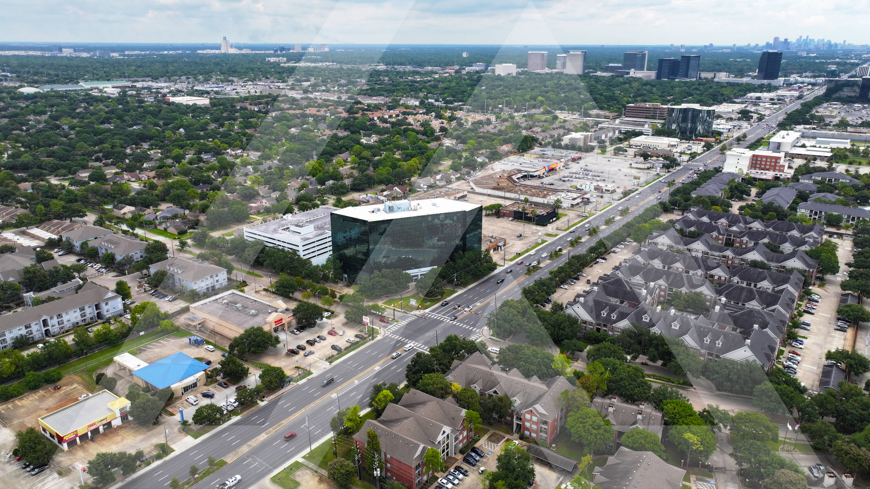 Aerial view of Royal Oaks Centre at 11490 Westheimer Rd, Houston, TX 77077, showcasing retail spaces and surrounding neighborhood.