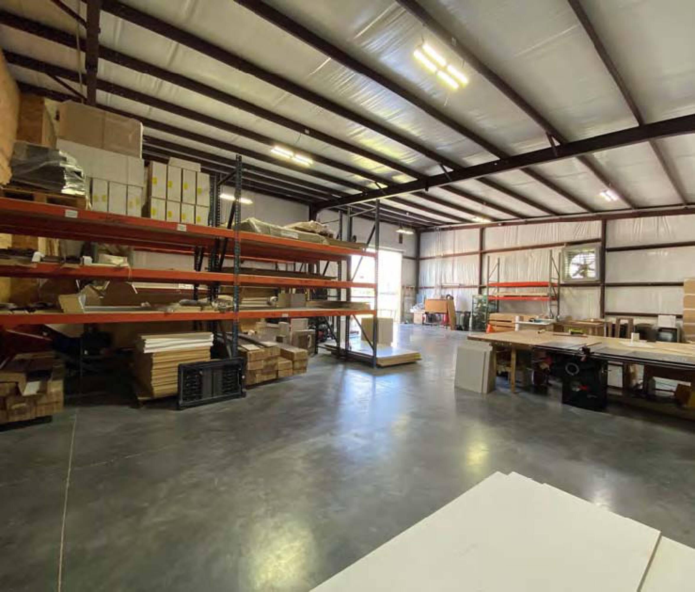Spacious industrial warehouse with high ceilings, wide aisles, and dock-high loading area.