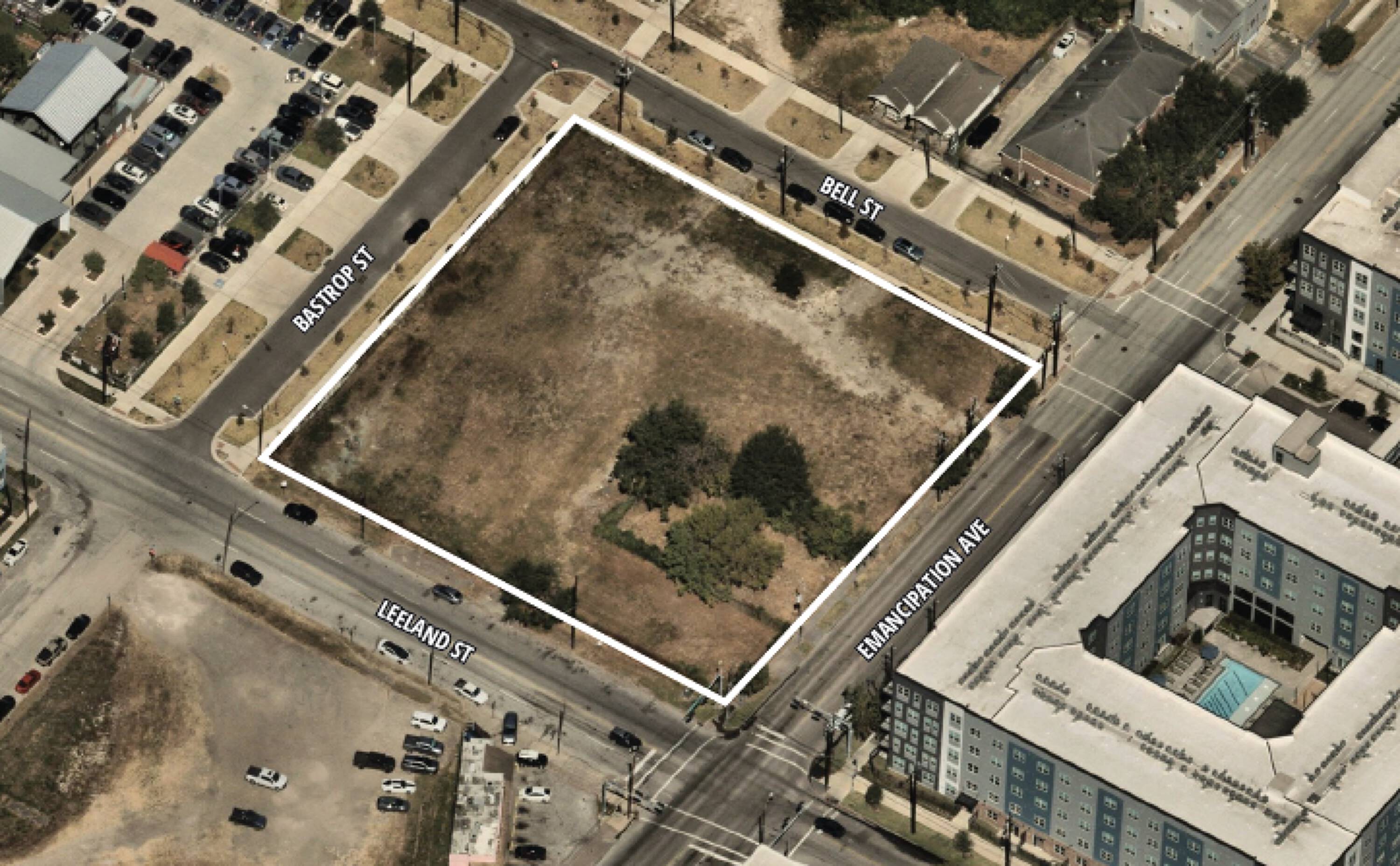 Aerial view of a ±1.43-acre vacant land parcel at 2323 Leeland St, Houston, TX, surrounded by residential and commercial properties.