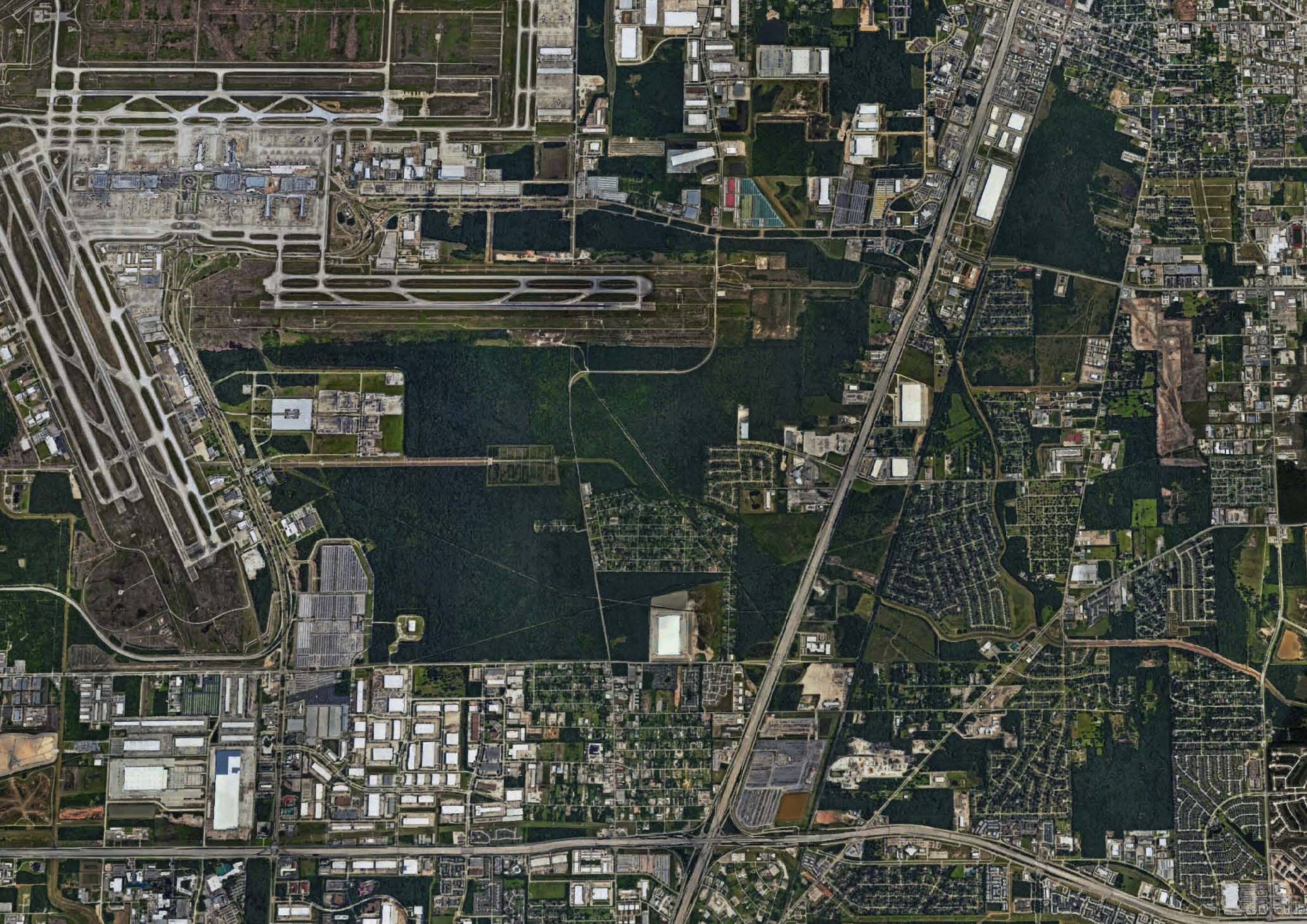 Aerial view of Mckay at Will Clayton Logistics Center in Humble, TX, showing its proximity to an airport and extensive parking.