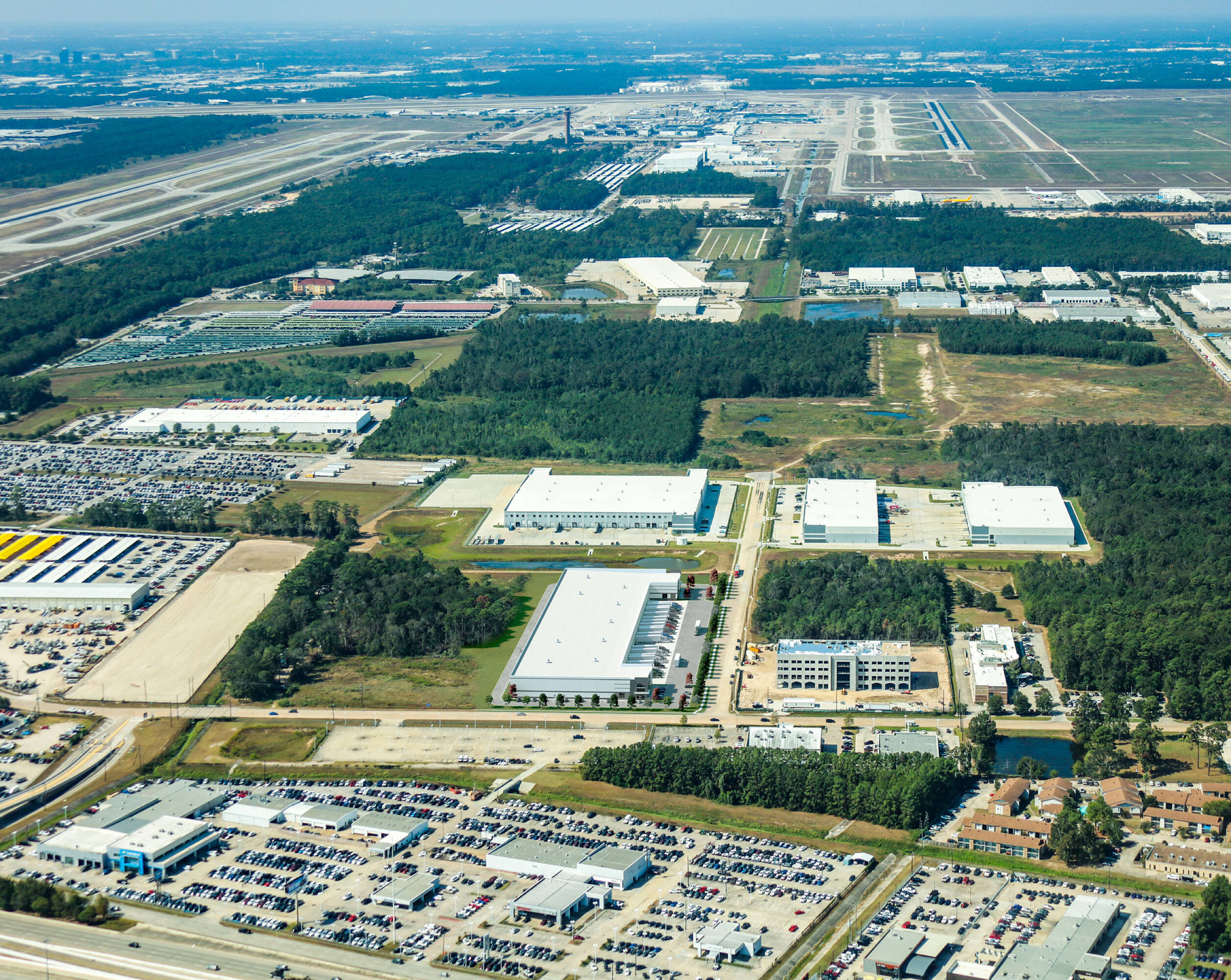 Aerial view of Mckay at Will Clayton Logistics Center in Humble, TX, showcasing extensive parking and industrial surroundings.