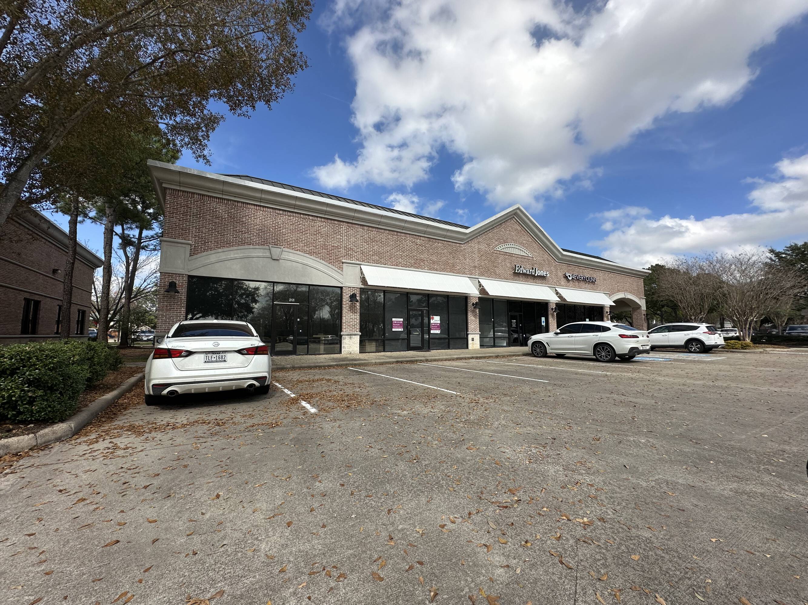 Exterior view of Westheimer Parkway Retail Center with ample parking and modern brick facade.