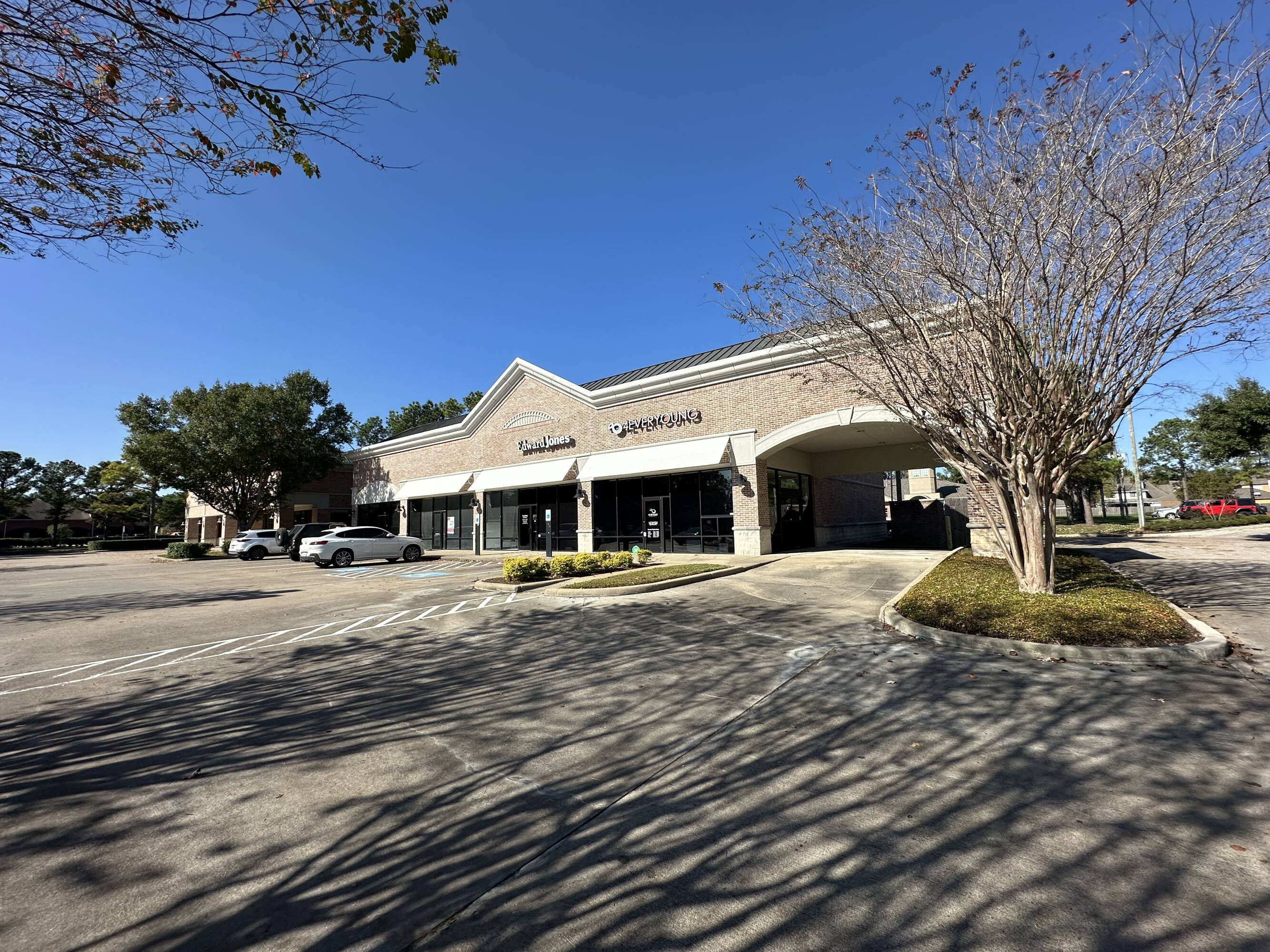 Front view of Westheimer Parkway Retail Center with brick facade, large windows, and surface parking.