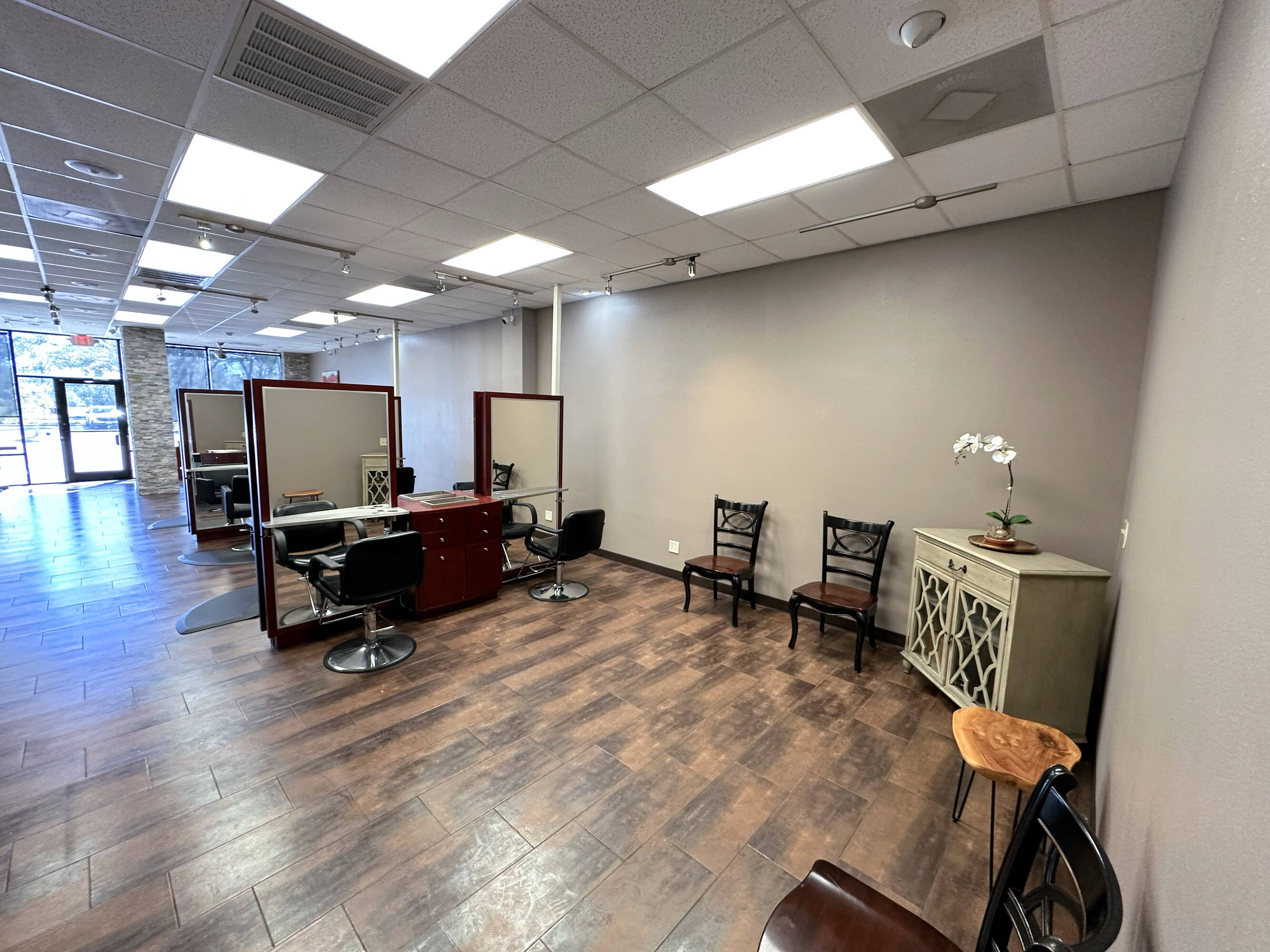Interior view of a modern salon space with ample natural light and stylish decor at Westheimer Parkway Retail Center.