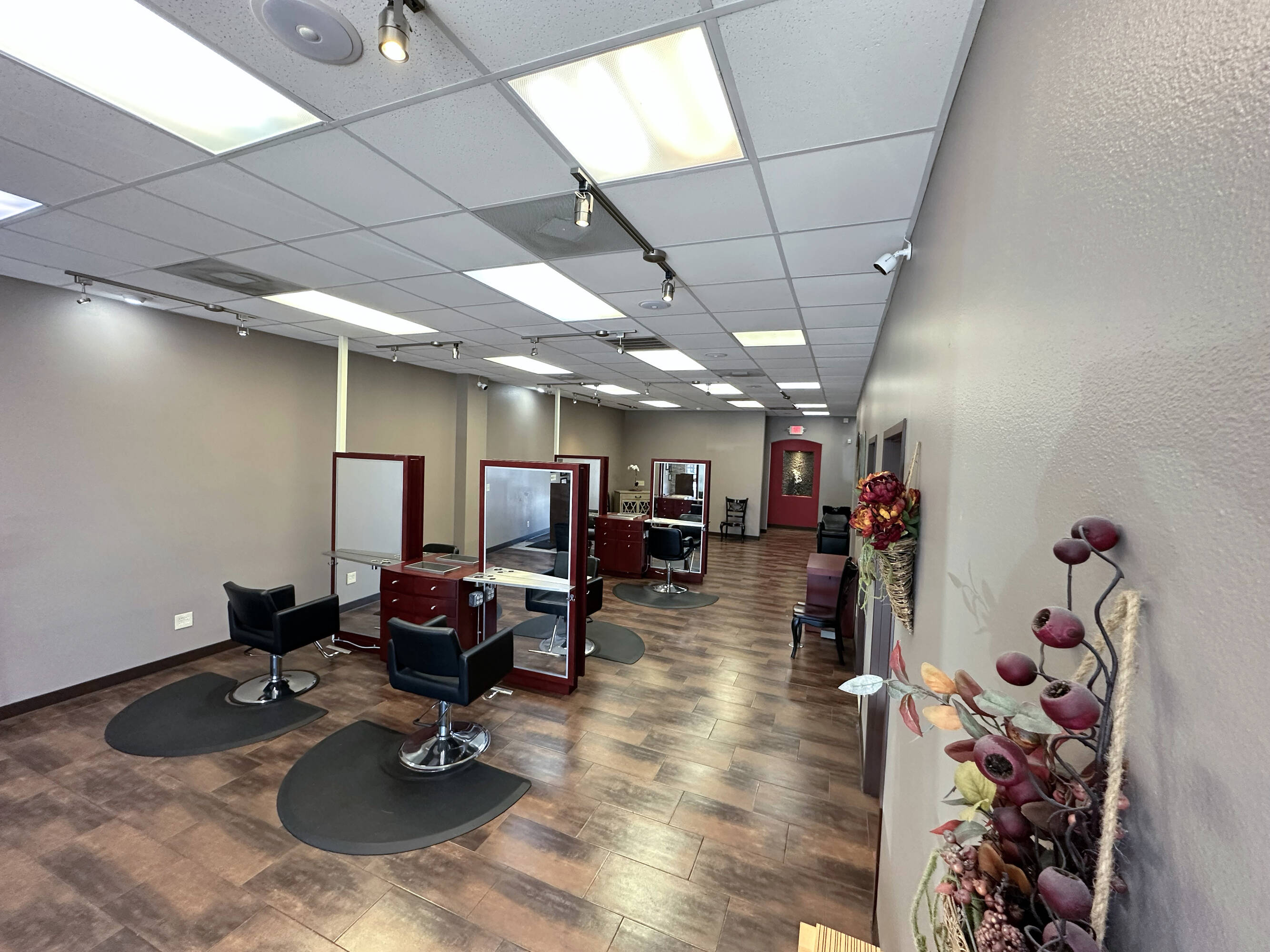 Interior of a modern salon space with styling stations and bright overhead lighting at Westheimer Parkway Retail Center.