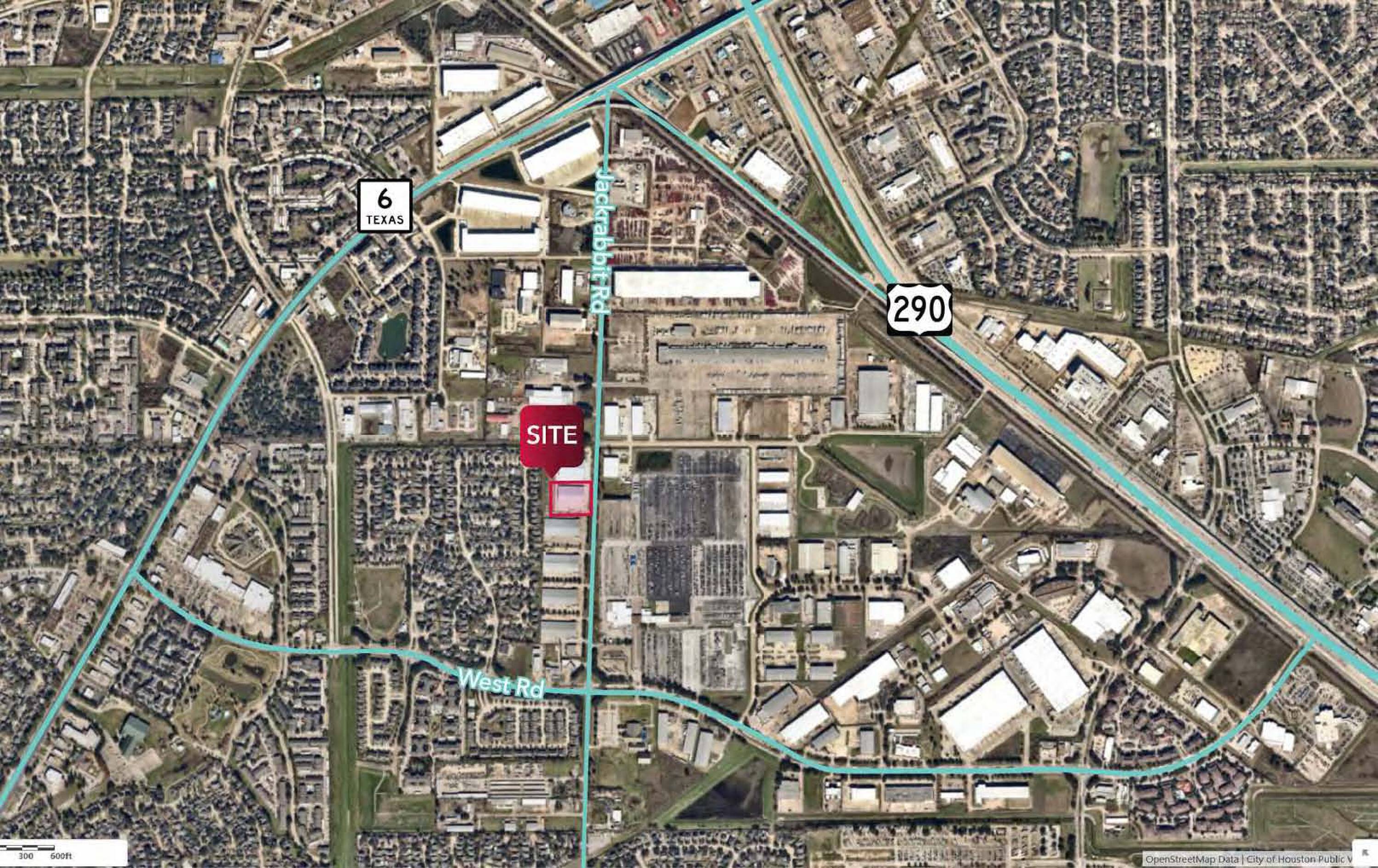 Aerial view of 8715 Jackrabbit Rd, Houston, TX, showing an industrial property with ample parking and access points.