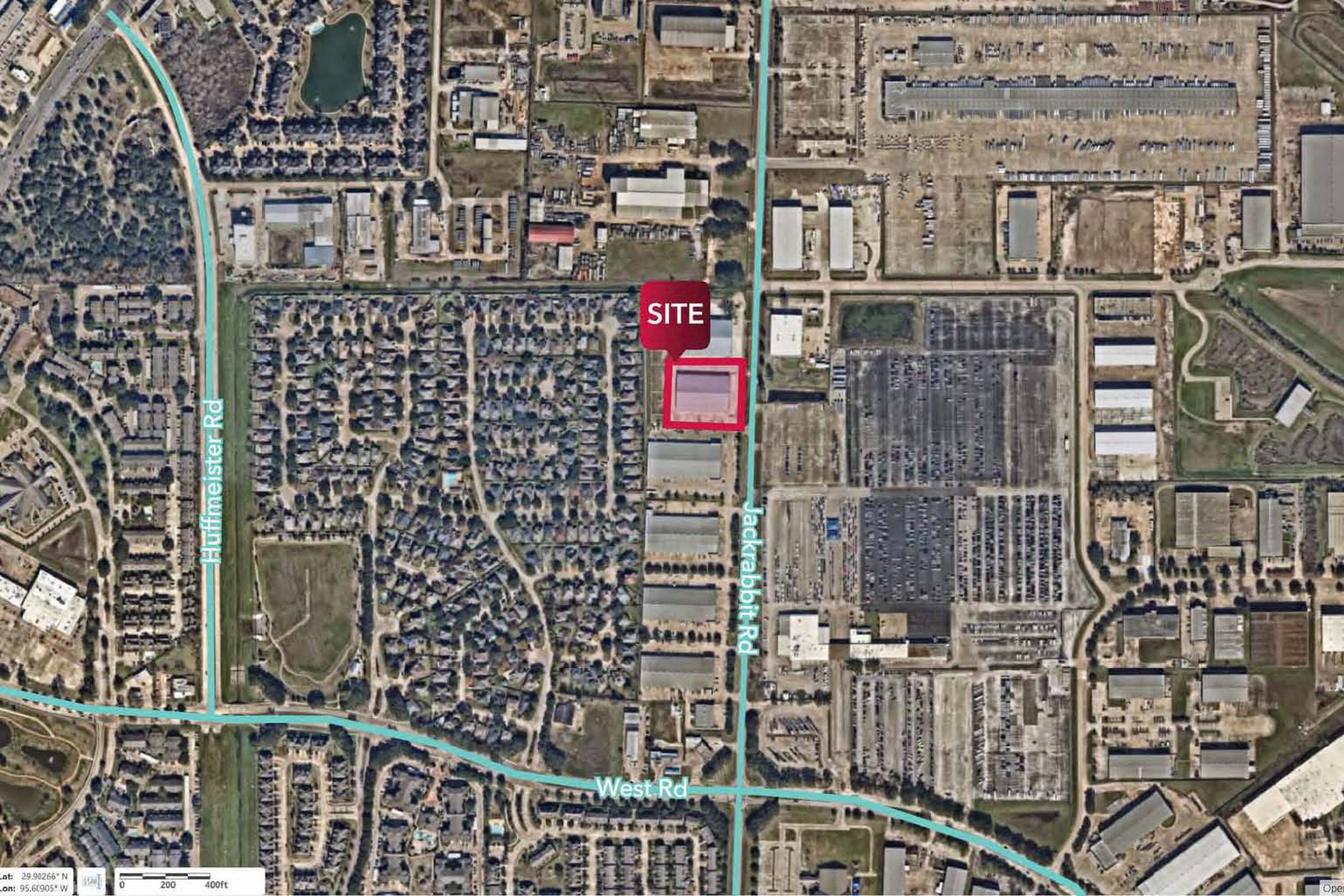 Aerial view of 8715 Jackrabbit Rd, Houston, TX, showcasing an industrial property with ample parking and loading areas.