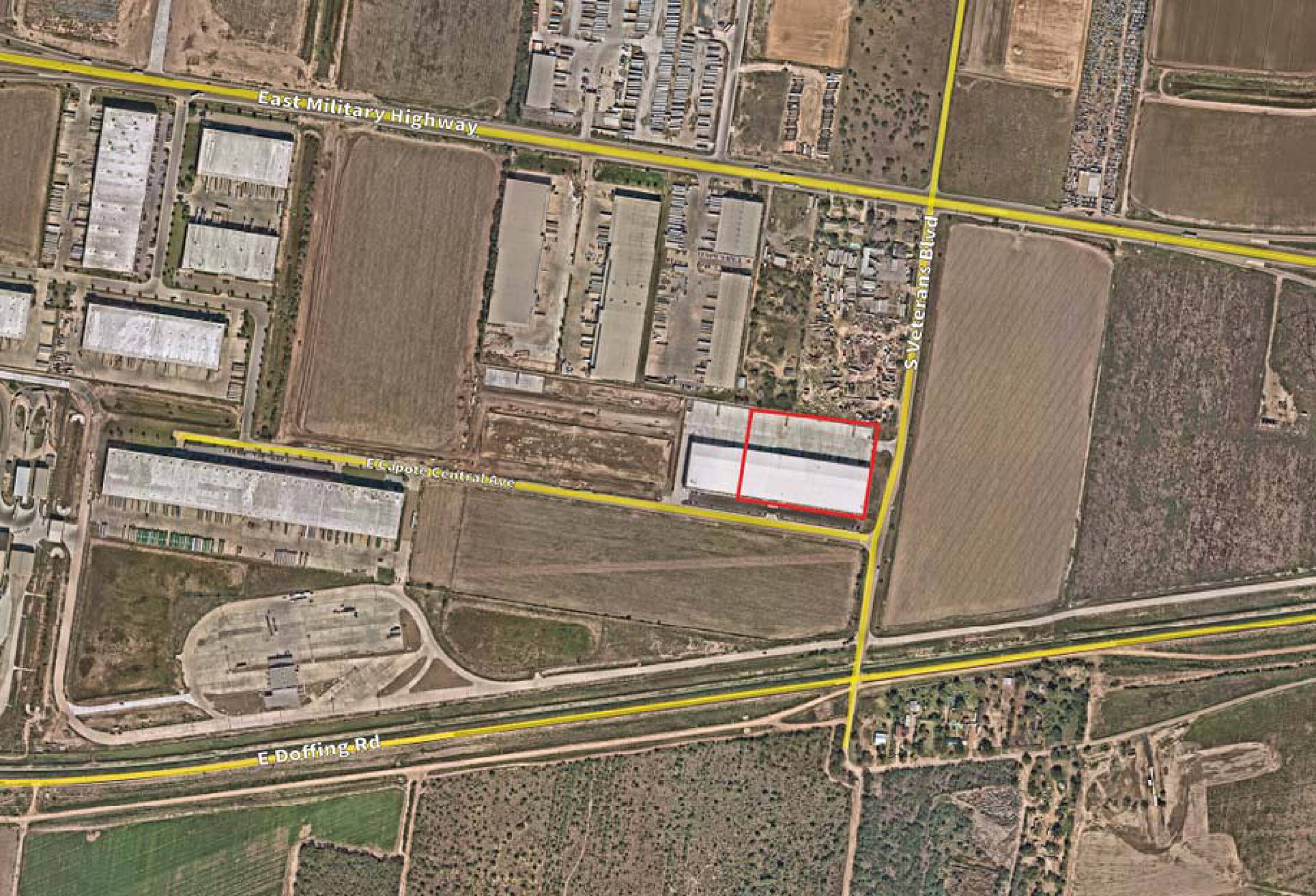 Aerial view of Capote International Business Park, showcasing industrial buildings, parking, and surrounding infrastructure.