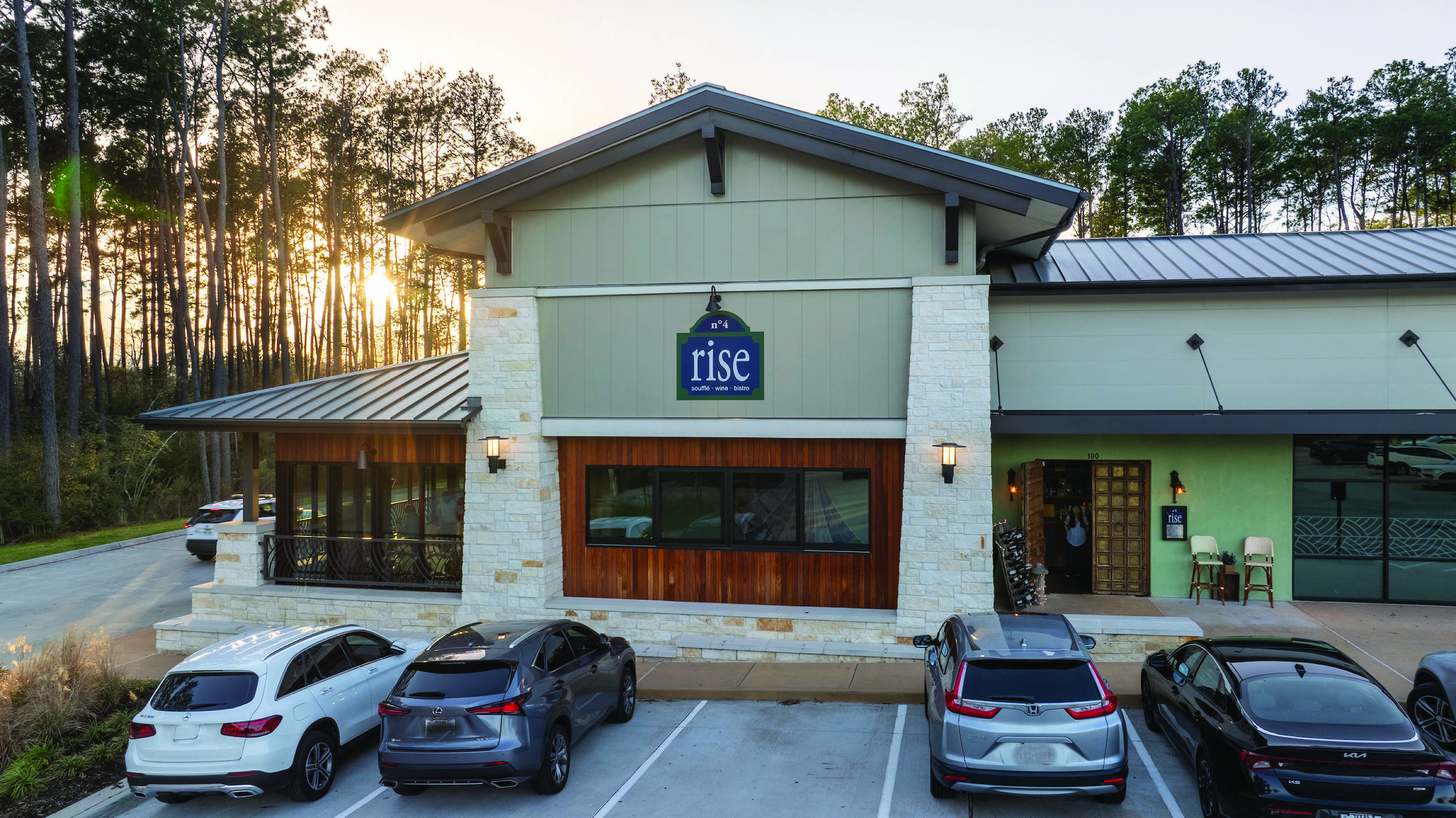 Front view of a fully leased retail center with ample parking and natural light at Creekside Park Village Center in Spring, TX.