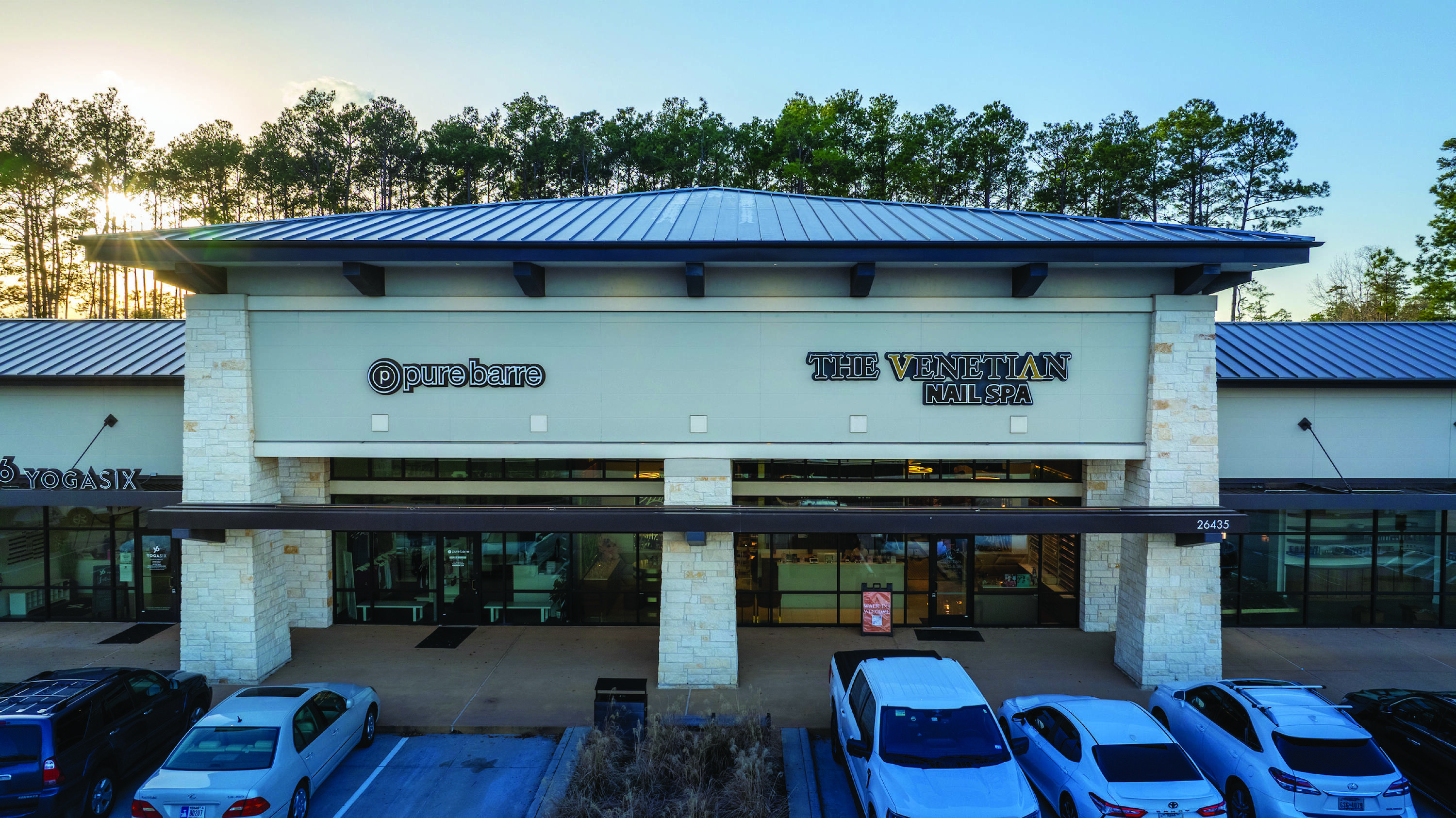 Aerial view of a fully leased retail center with ample parking and prominent tenant signage.