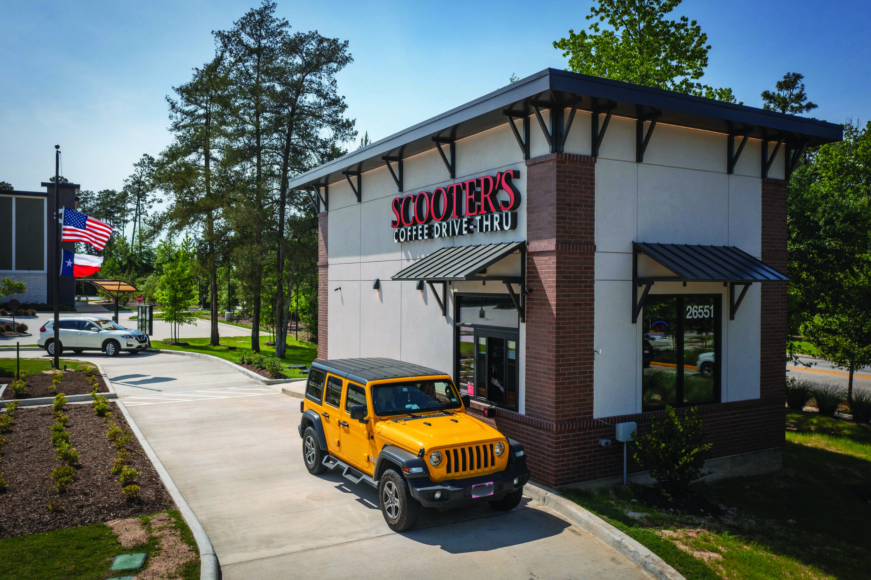 A well-maintained retail building with a drive-thru for Scooter's Coffee at Creekside Park Village Center.